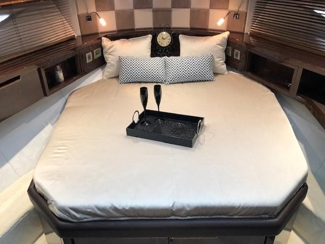Luxurious bedroom interior of 2018 Galeon 485 yacht with elegant bedding and decor.