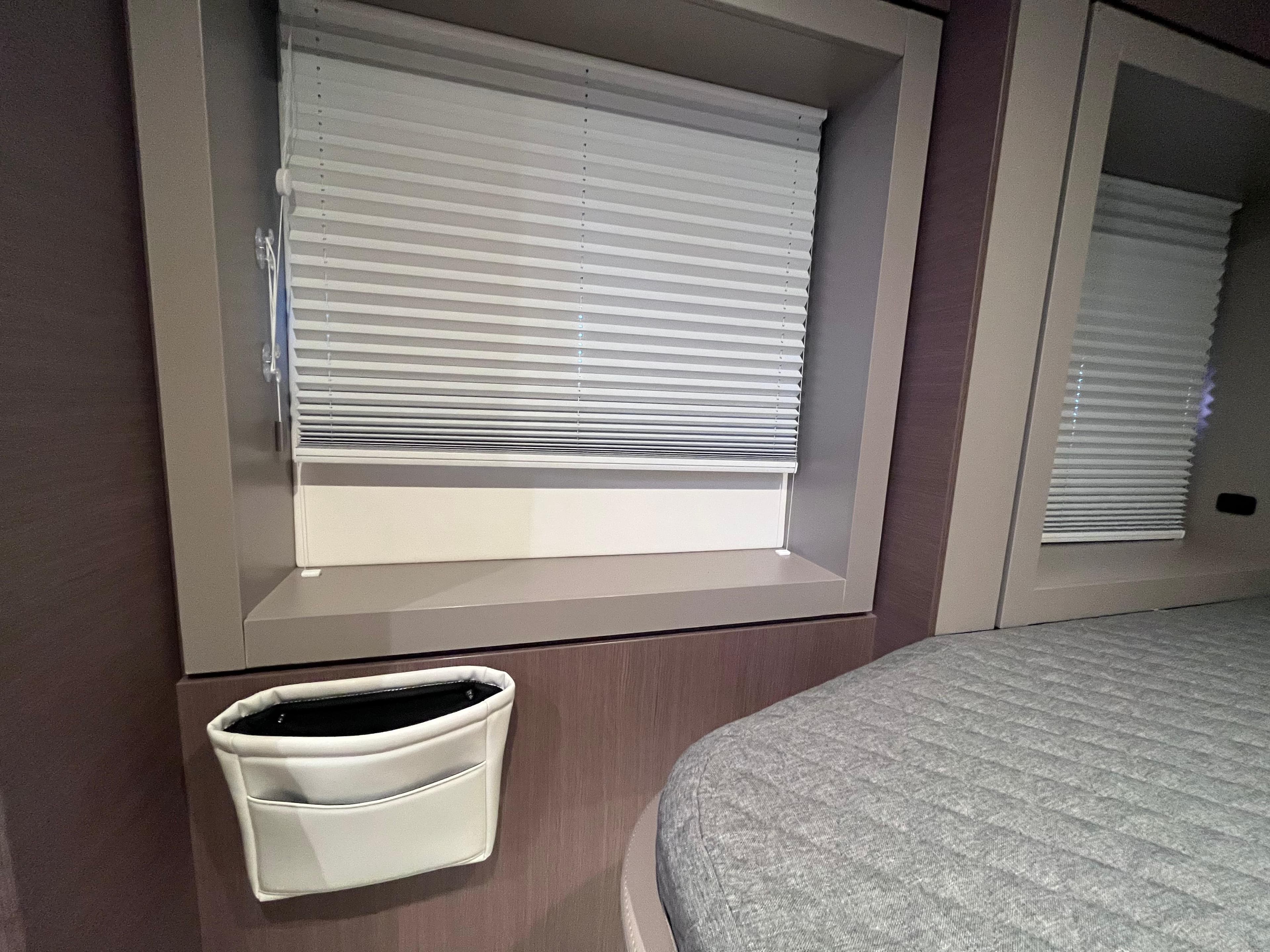 Interior of a 2021 Bali 4.6 yacht with window blinds and a bed.