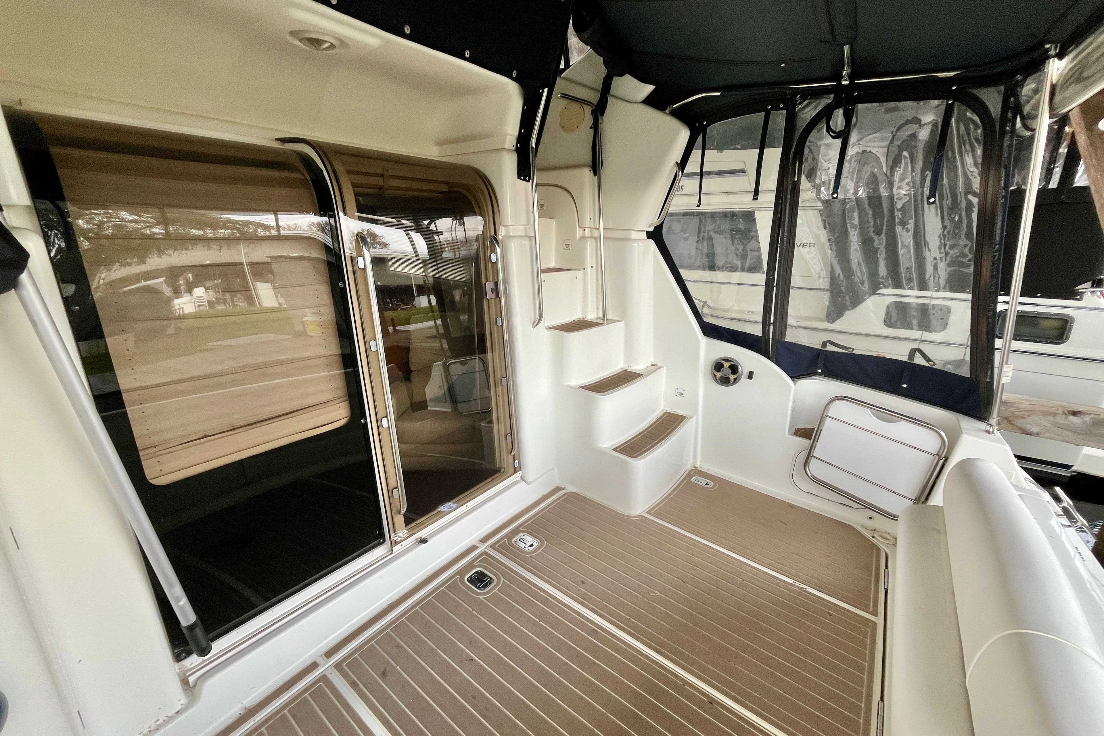1997 Silverton 362 Sedan Cruiser interior with wooden flooring and seating area.