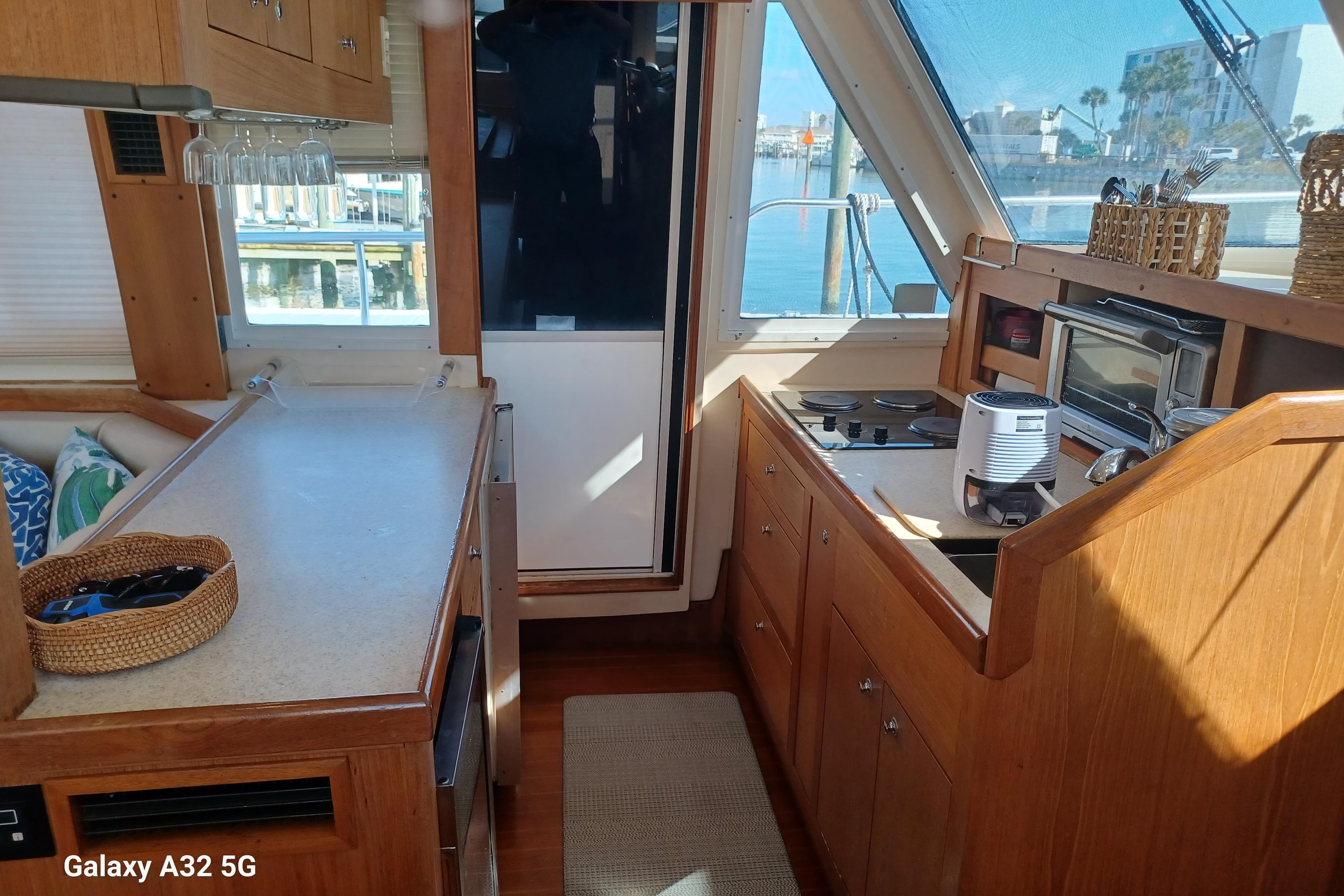 Interior of 1999 Mainship 43 Trawler Aft Cabin with kitchen and seating area.
