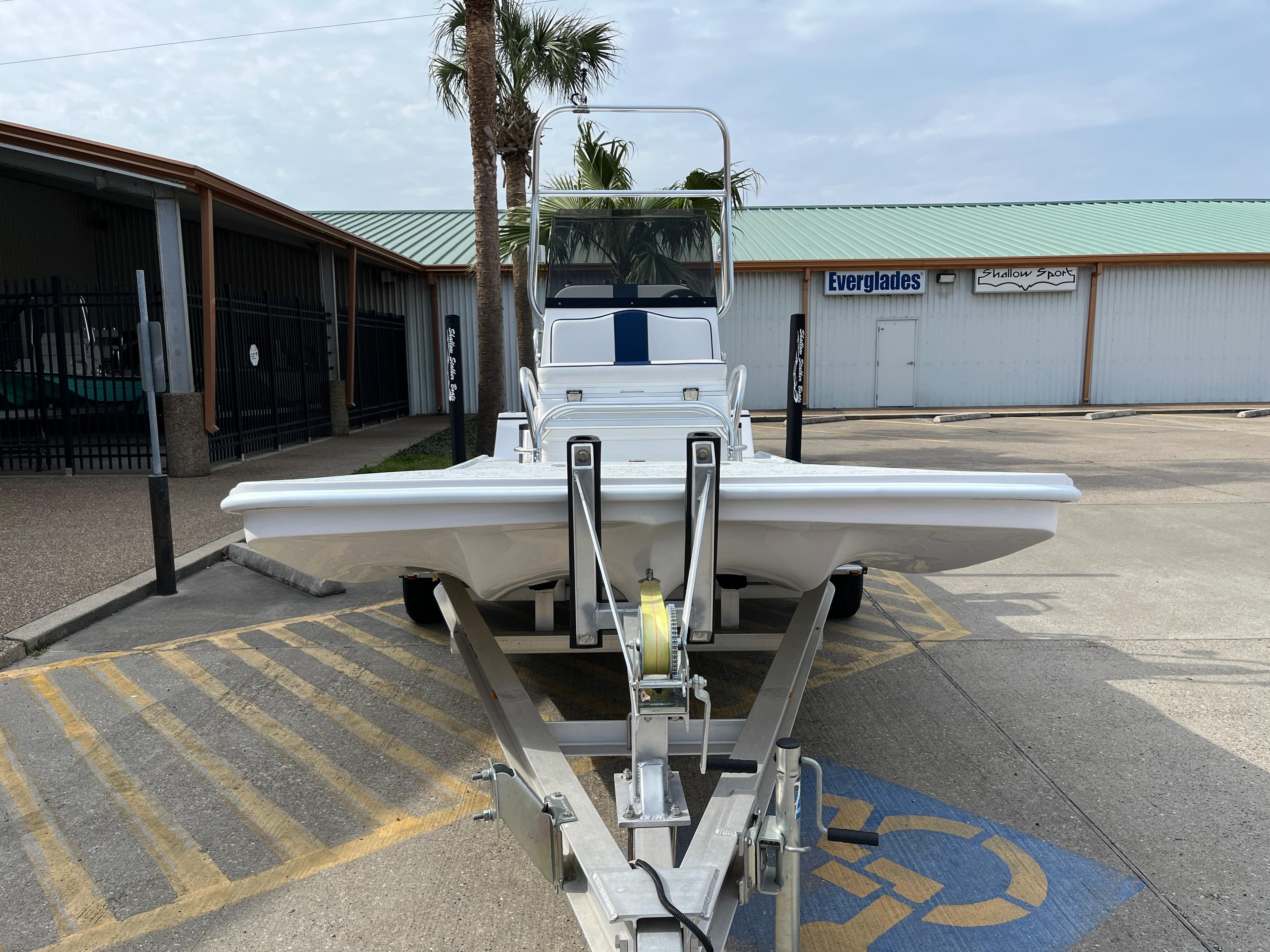 2024 Shallow Stalker SS-17 Sportsman boat on a trailer in a parking lot.