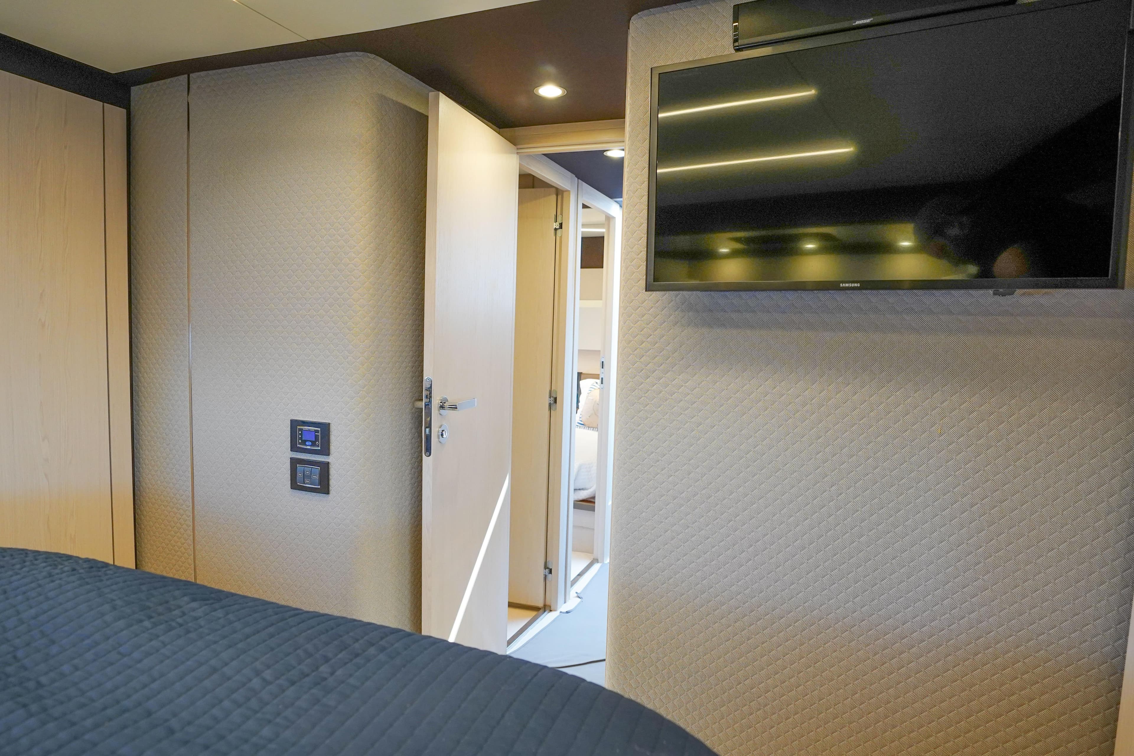 Luxurious interior of 2017 Azimut 66 Flybridge yacht with TV and modern decor.