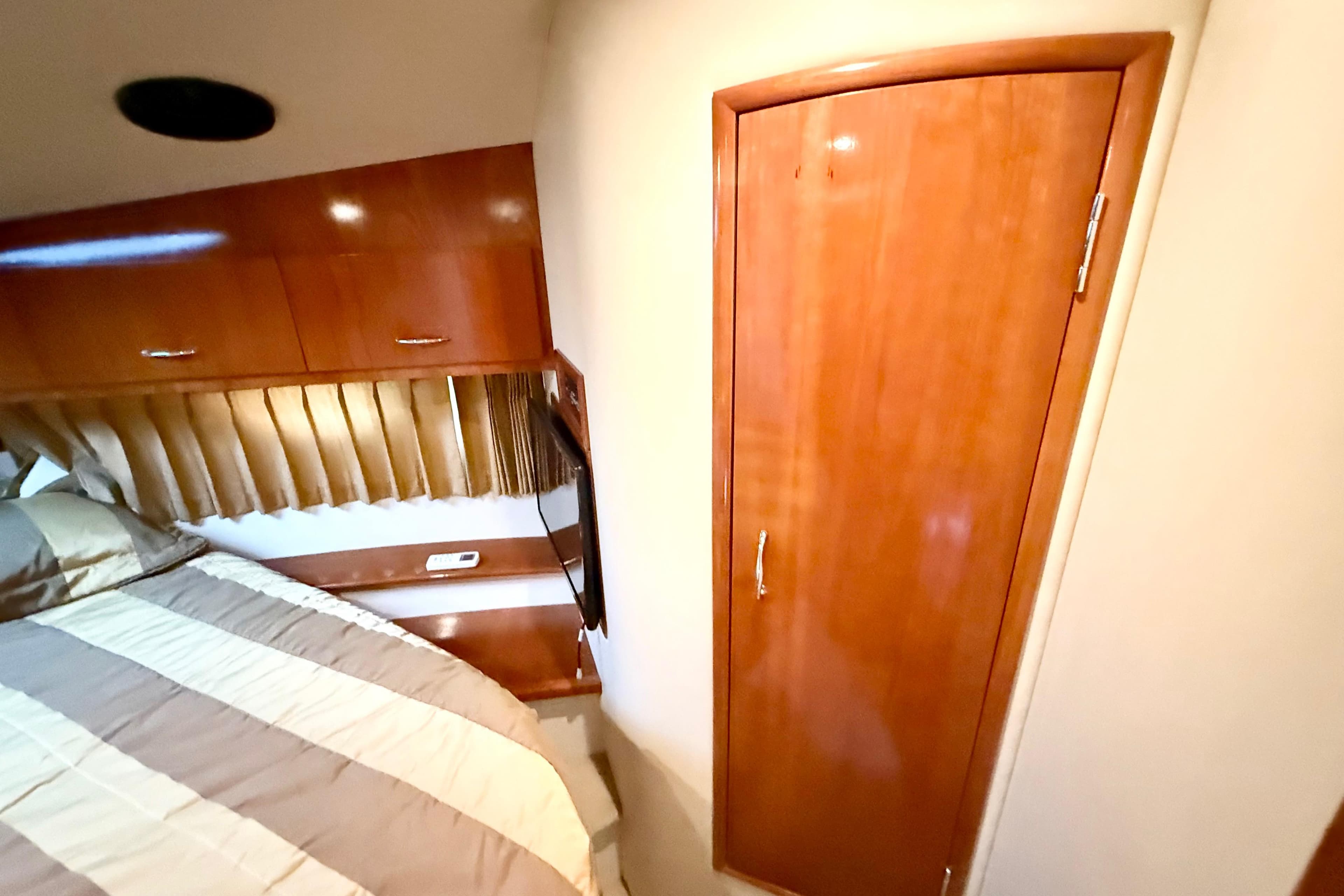 Interior of 2004 Carver 360 Sport Sedan with wood cabinetry and bed.