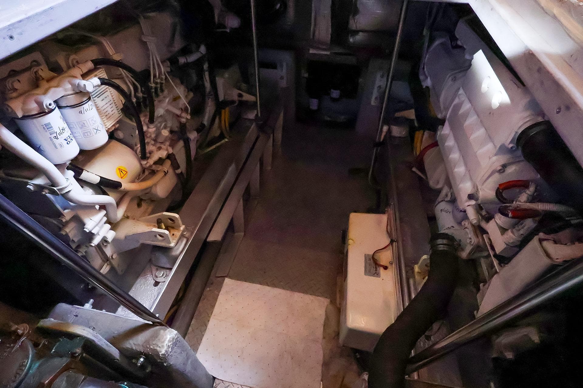 Engine room of a 2002 Silverton 43 Motor Yacht, showcasing mechanical components.