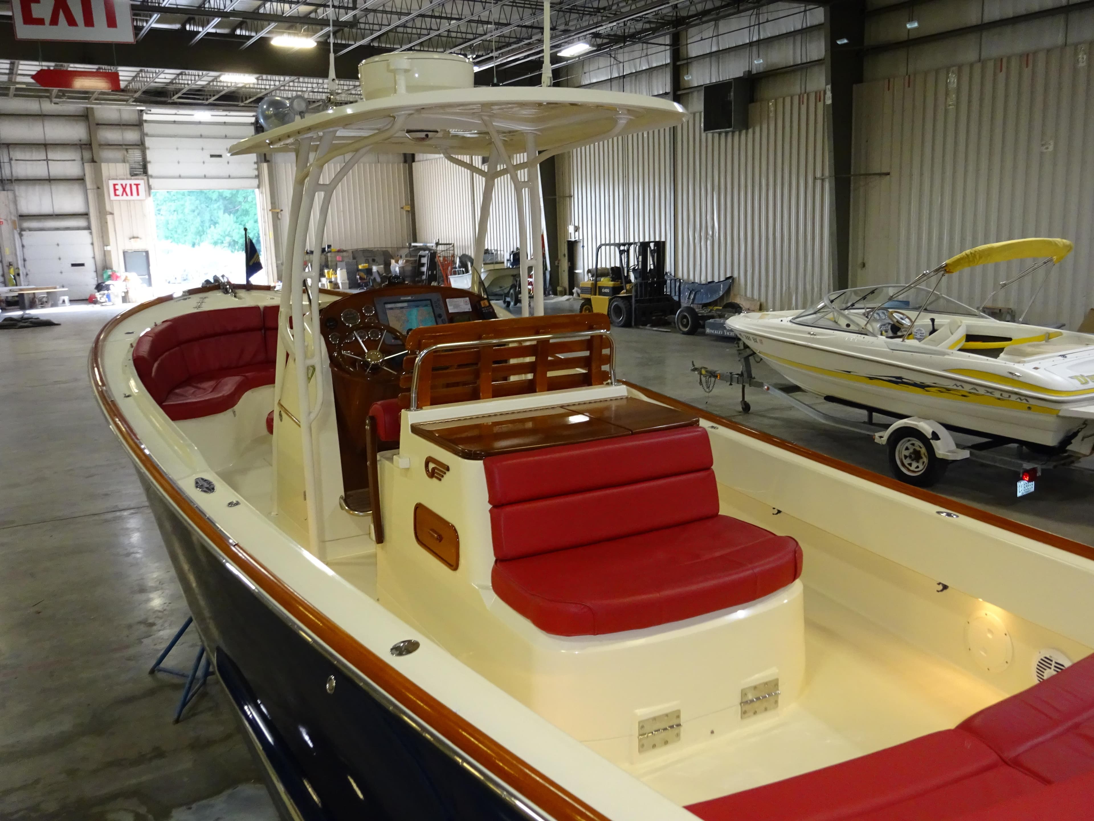 2007 Hinckley T29C boat with red seating, displayed indoors.