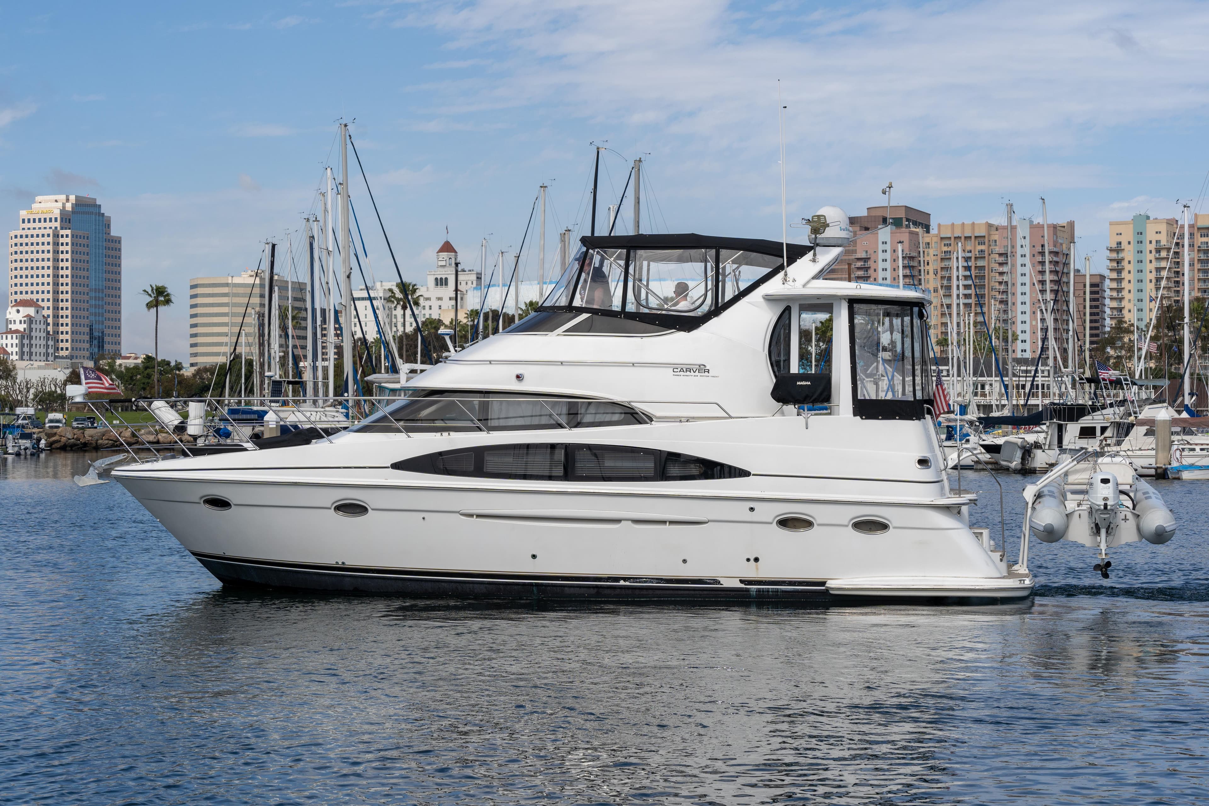 2001 Carver 396 Motor Yacht docked with city skyline in background.