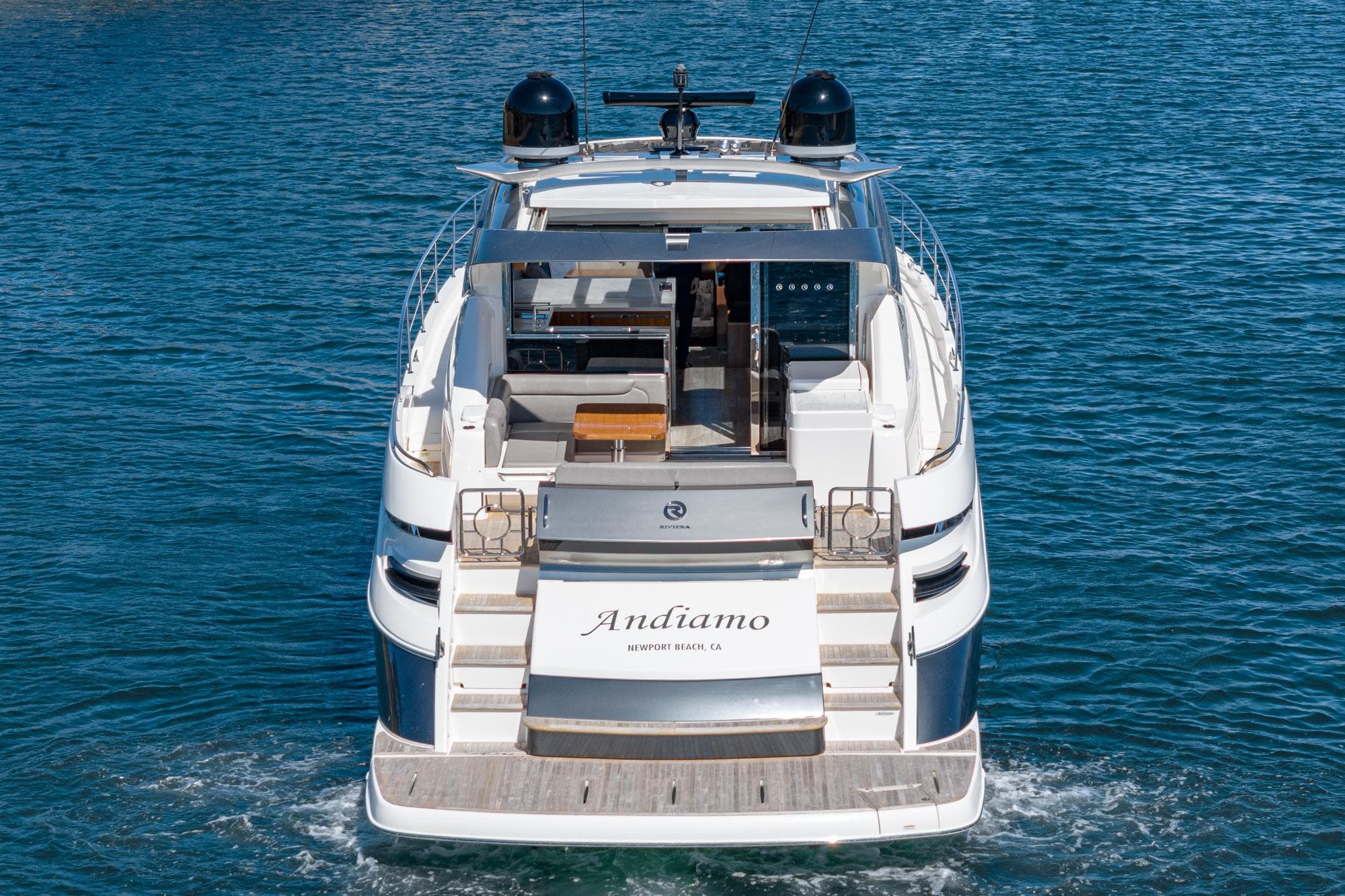 2020 Riviera 6000 Sport Yacht on water, rear view, luxury design.