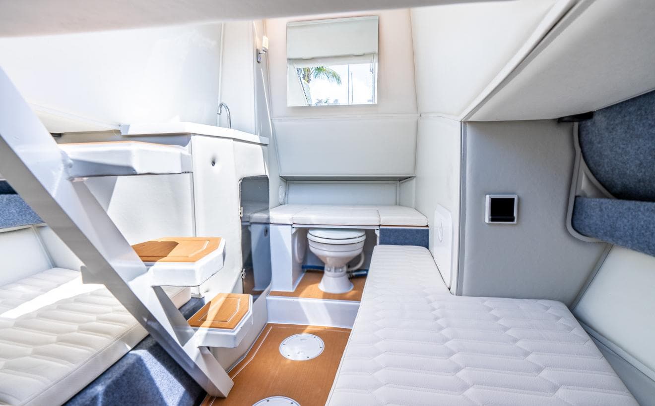 Interior of 2026 Novielli Veloche 349 boat, featuring compact bathroom and seating area.