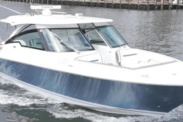 2021 Tiara Sport 38 LX boat cruising on water, featuring sleek design and modern amenities.