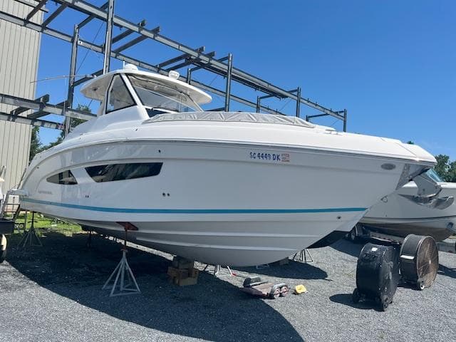 2019 Regal 33 SAV boat on stands in a storage yard.
