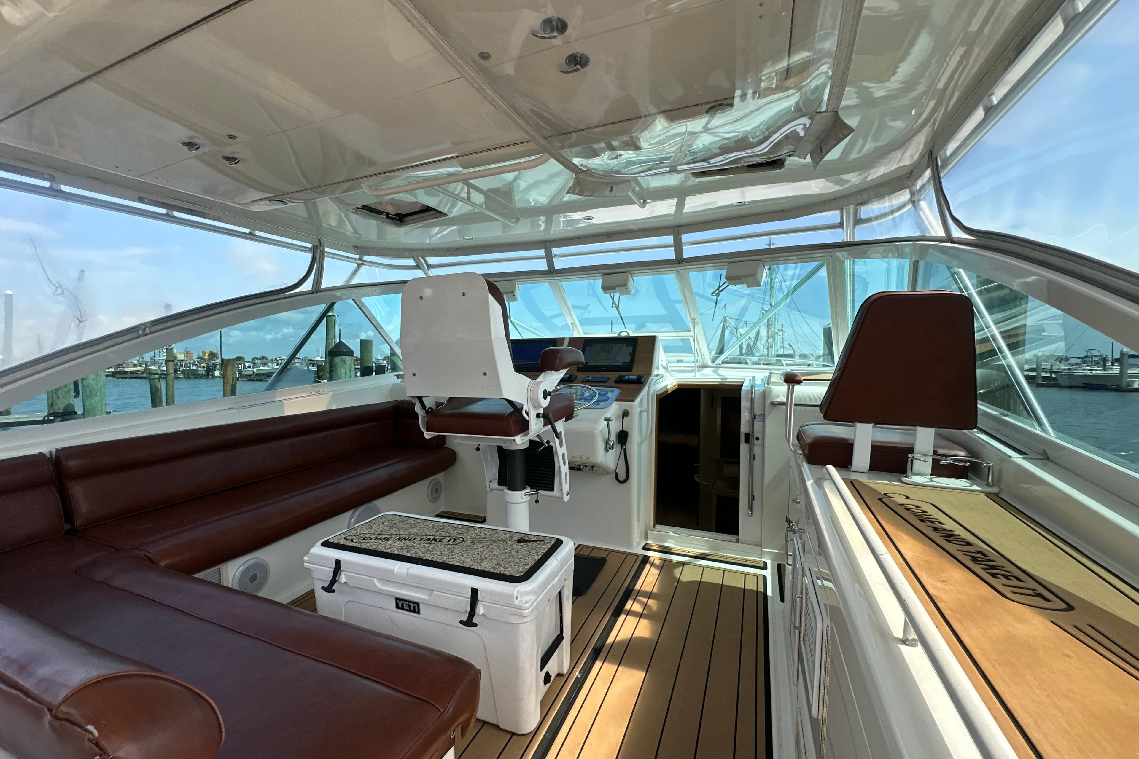 Interior of 2000 Cabo 45 Express yacht with leather seating and navigation equipment.
