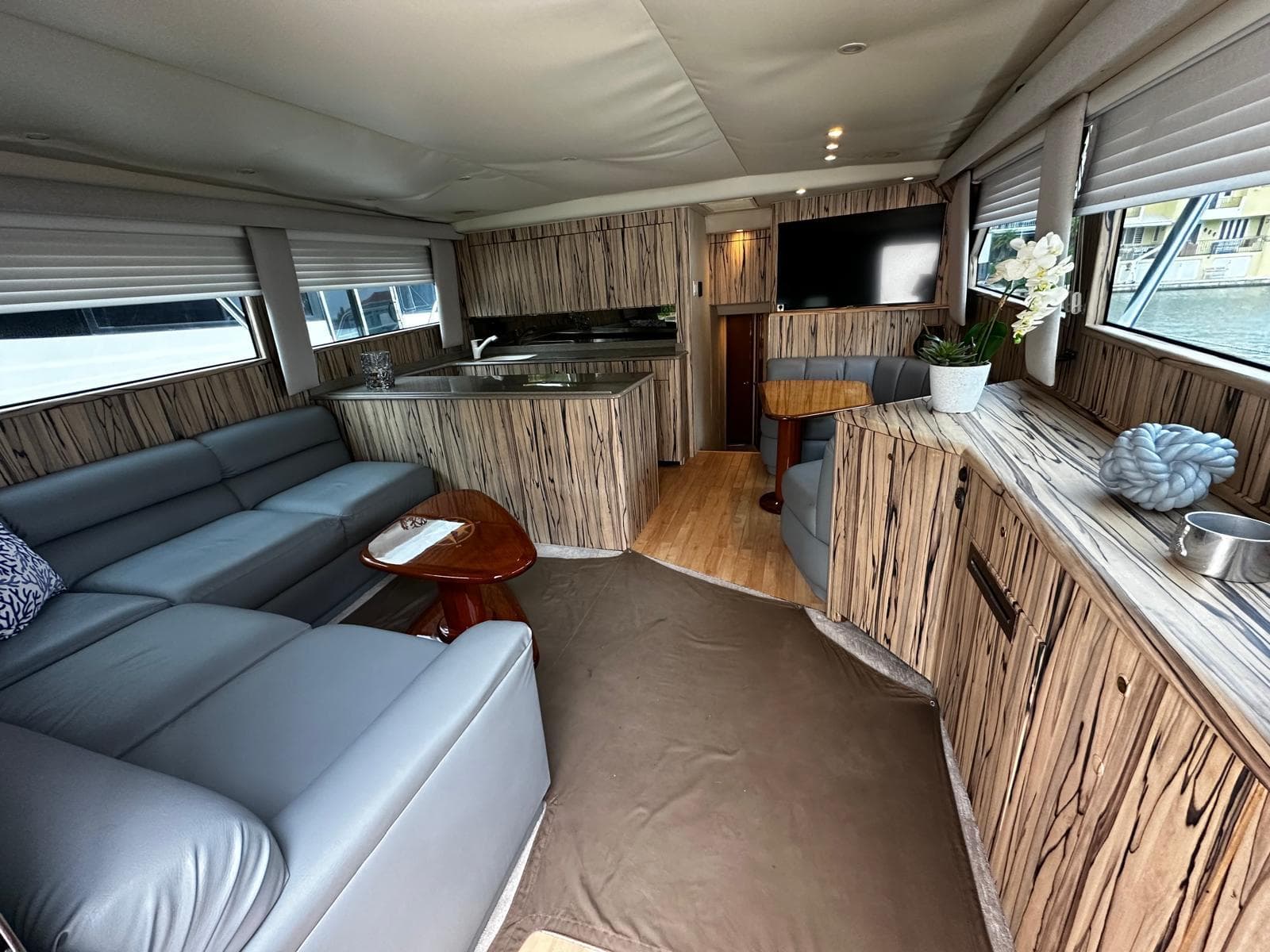 Luxurious interior of a 2003 Viking 52 yacht with modern furnishings and ample natural light.