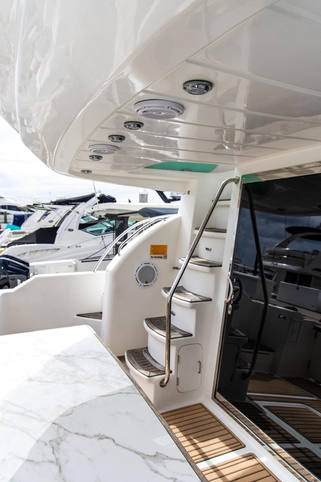 Luxury yacht interior with sleek design, featuring a staircase and polished surfaces, Dyna 50, 2002 model.