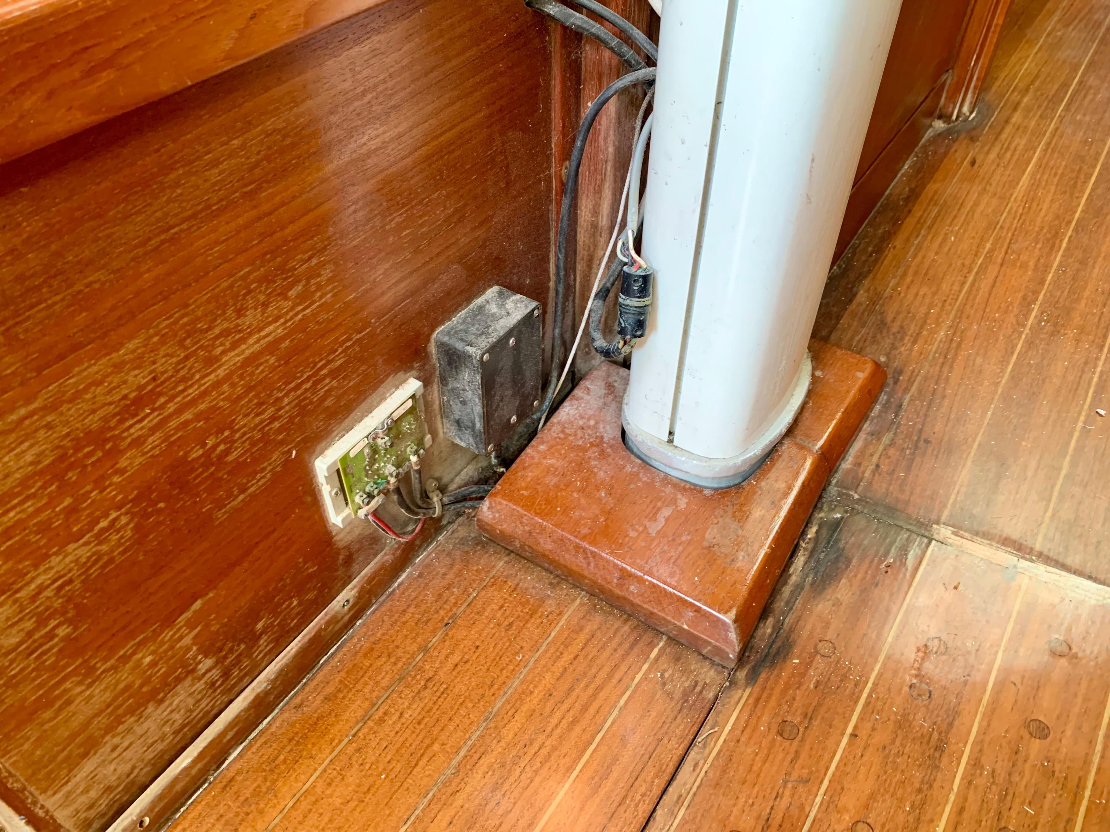 1986 Sabre 36 interior showing wooden flooring and electrical components near a mast base.