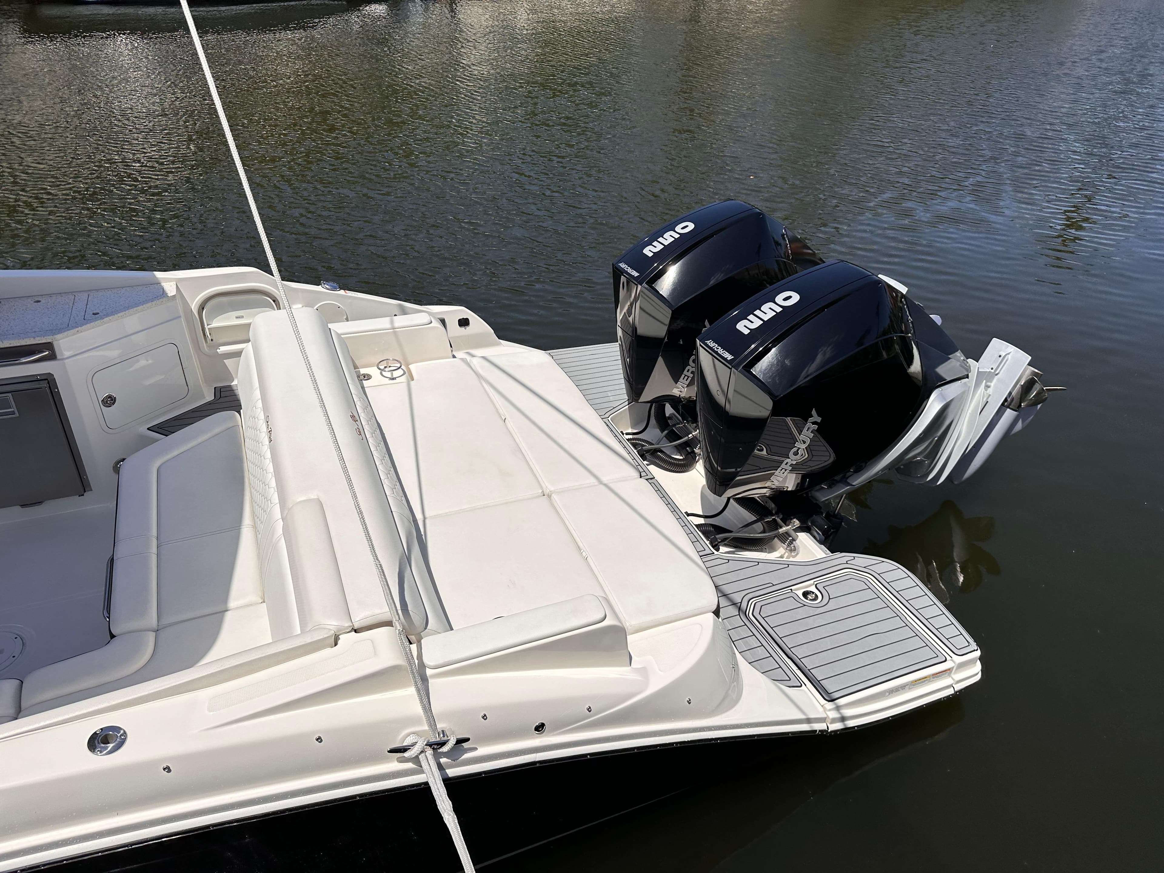 2021 Sea Ray SDX 290 Outboard with twin engines docked on calm water.