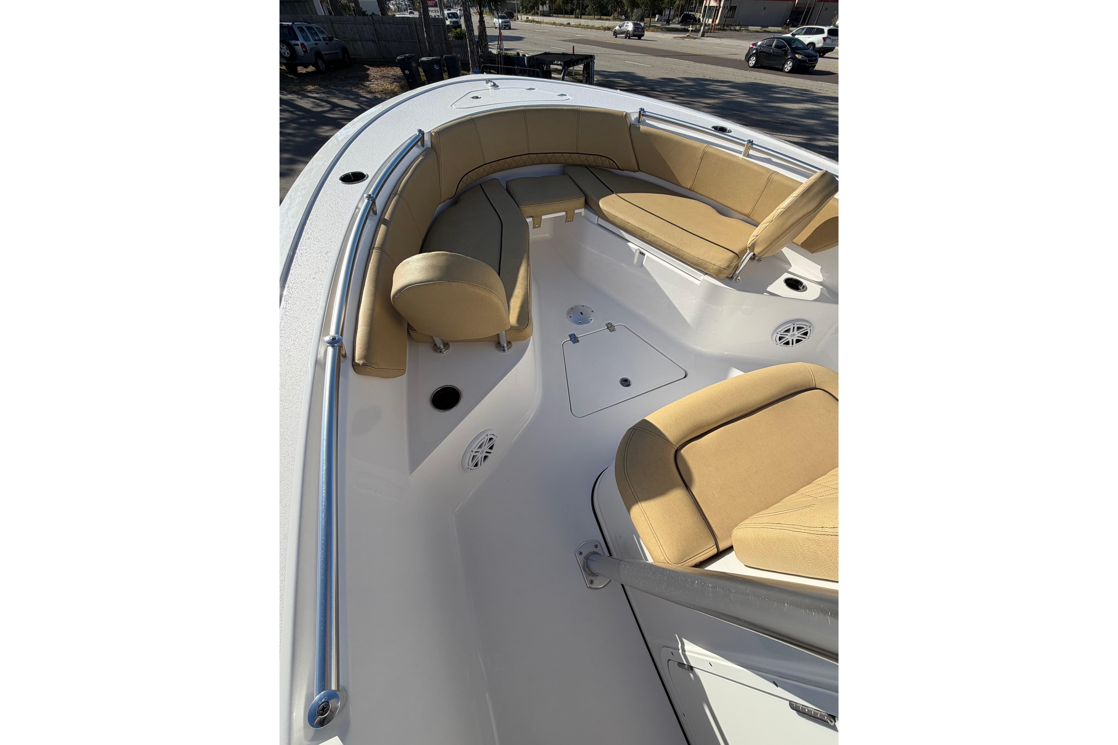2023 Sportsman Heritage 241 Center Console boat interior with tan seating and stainless steel railings.