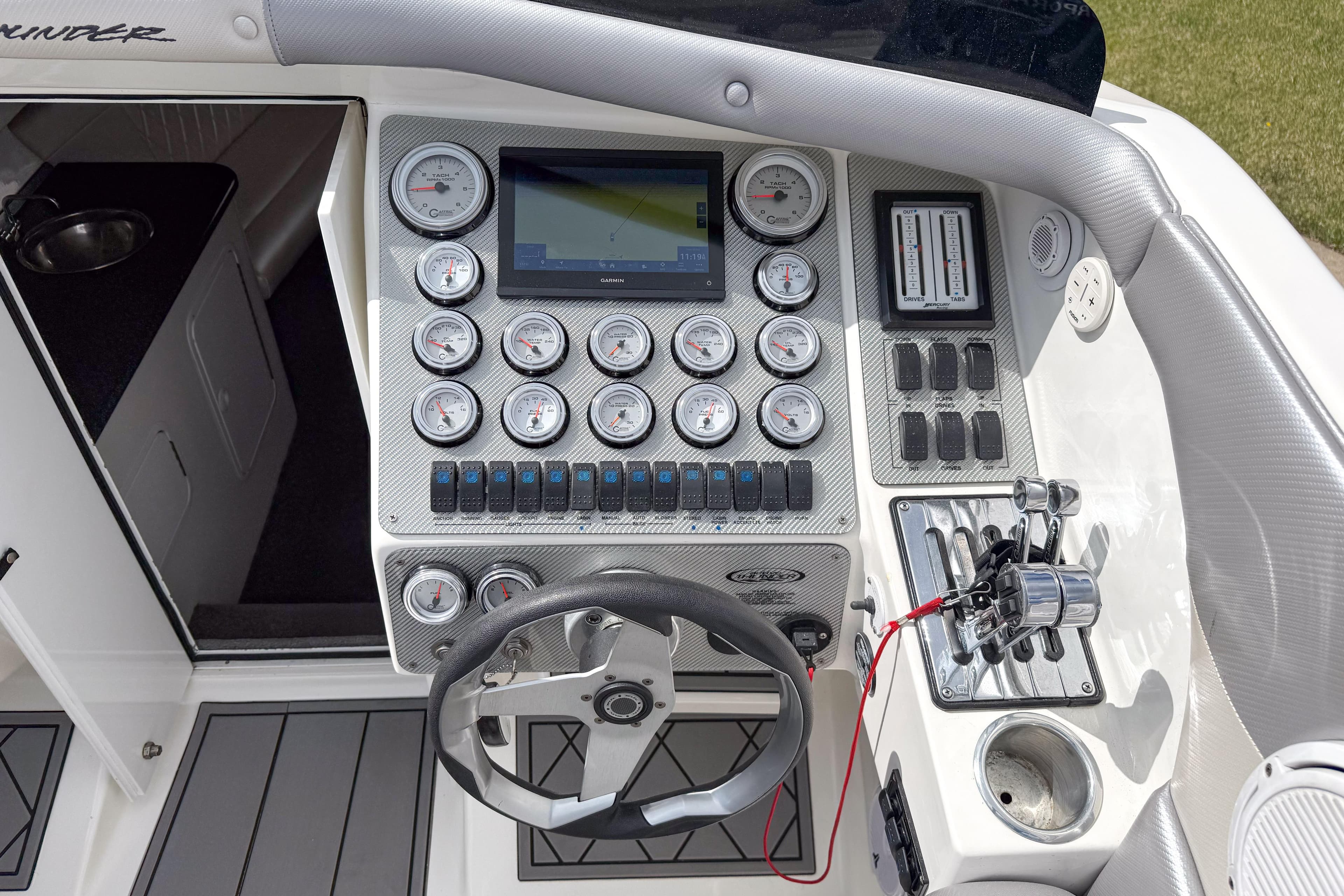 Cockpit of 2002 Active Thunder 37 boat with gauges, steering wheel, and controls.
