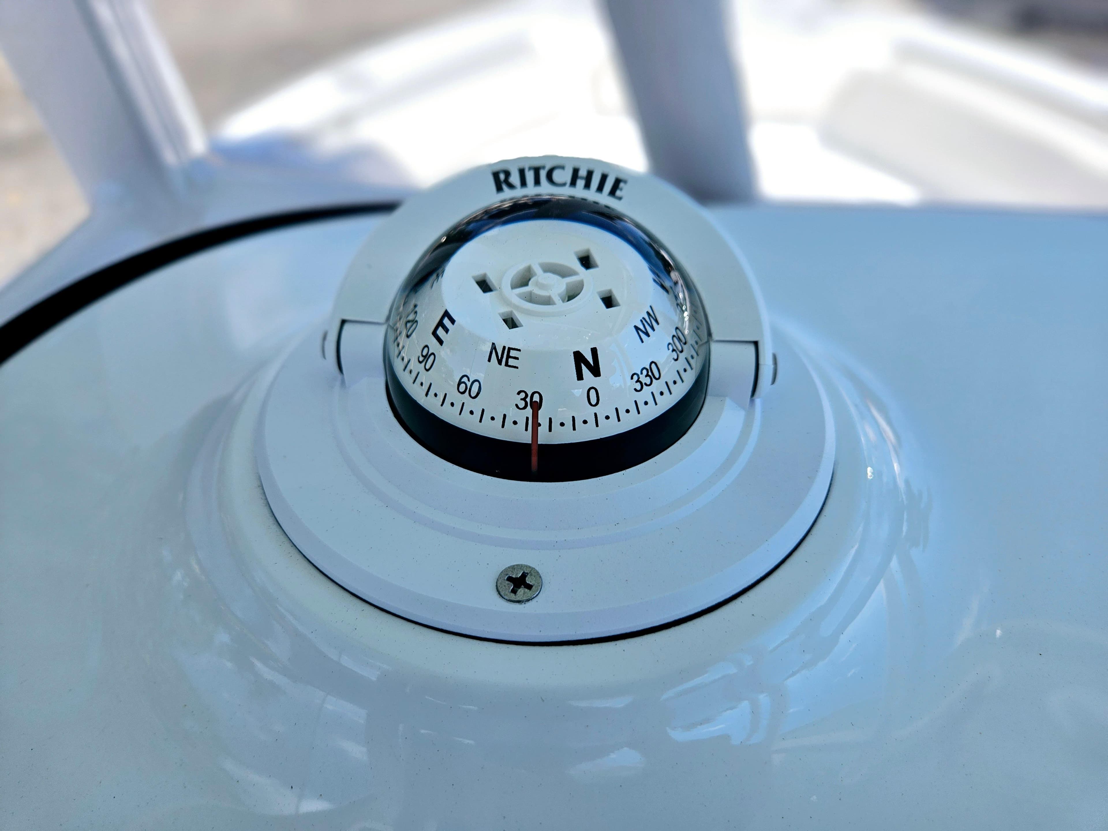 Compass on 2026 Sea Hunt Ultra 234 boat dashboard, displaying cardinal directions.