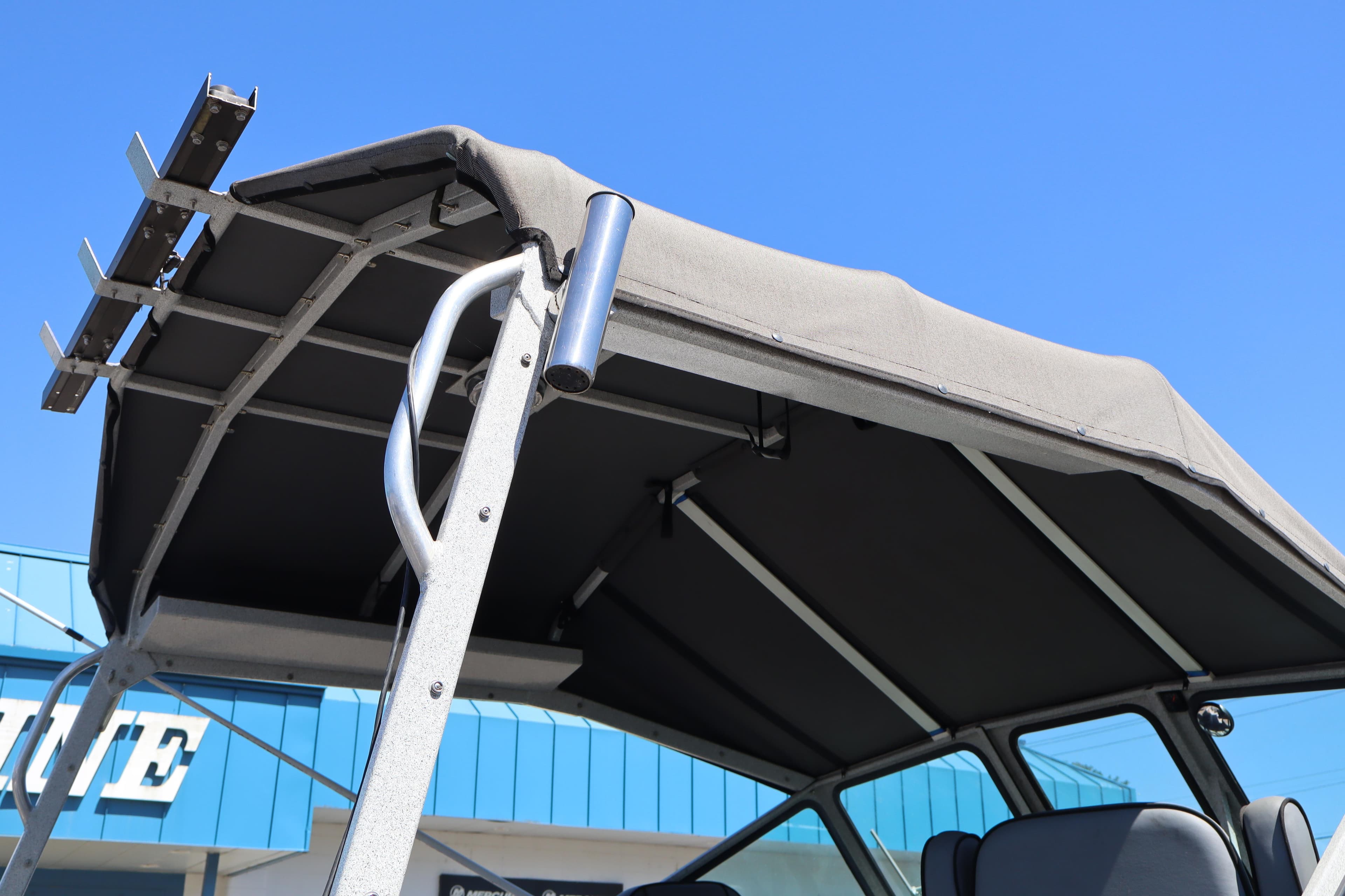 2006 Alumaweld Intruder Inboard 22 boat canopy and frame under clear blue sky.