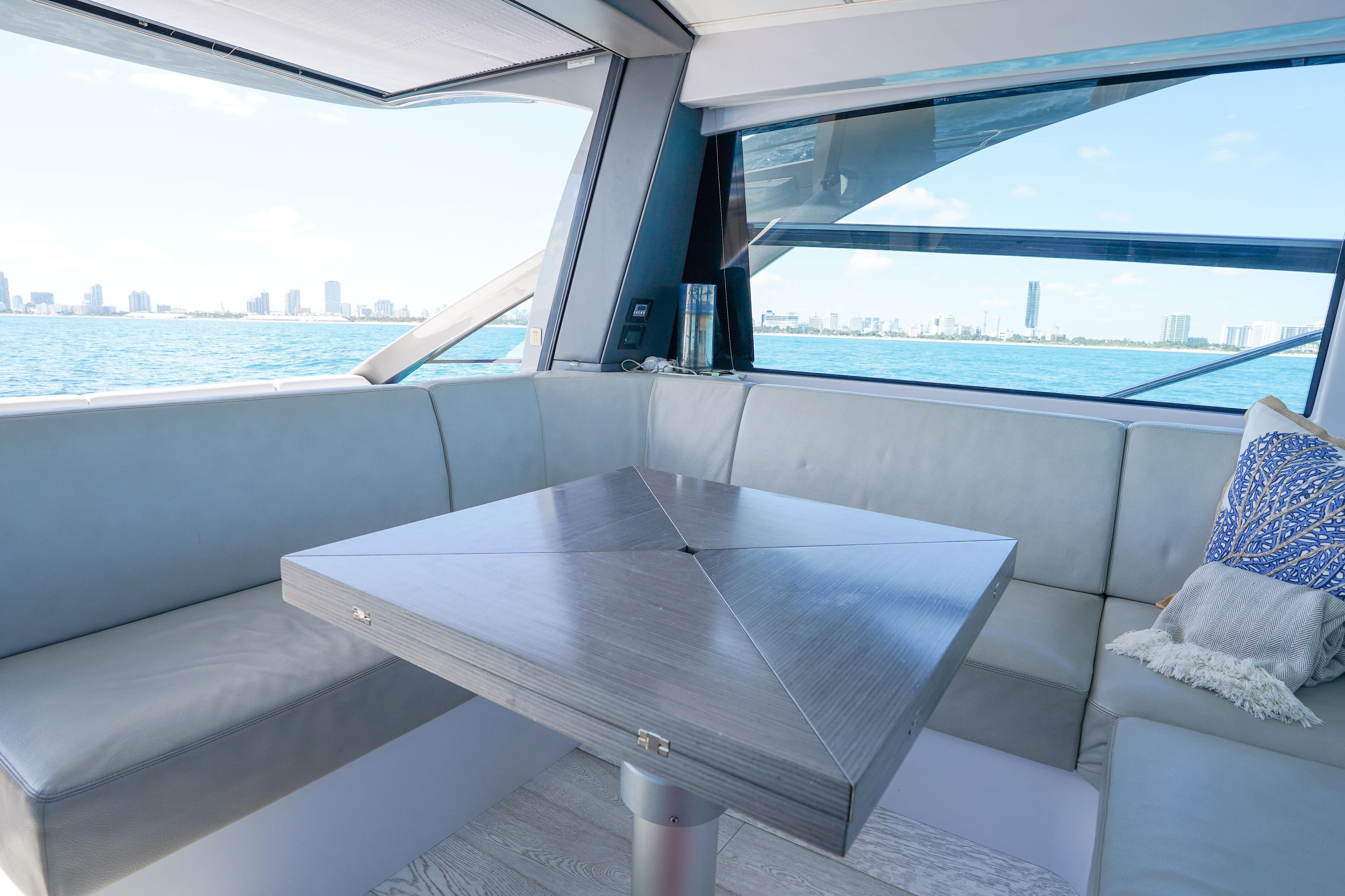 Luxurious interior of 2019 Pershing 5x yacht with ocean view and modern seating.