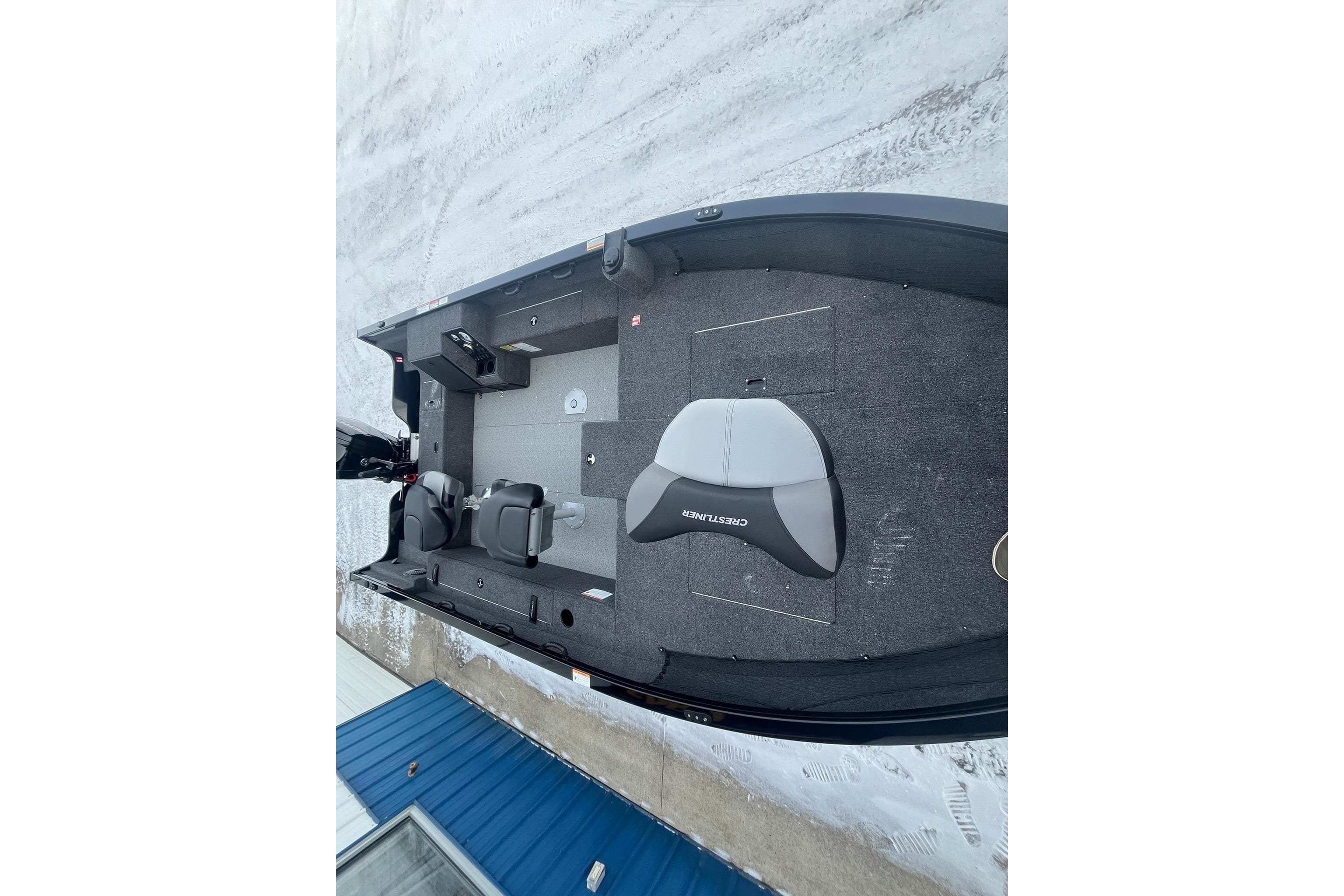 2026 Crestliner 1650 Pro Tiller boat interior with seating and controls, on snowy ground.