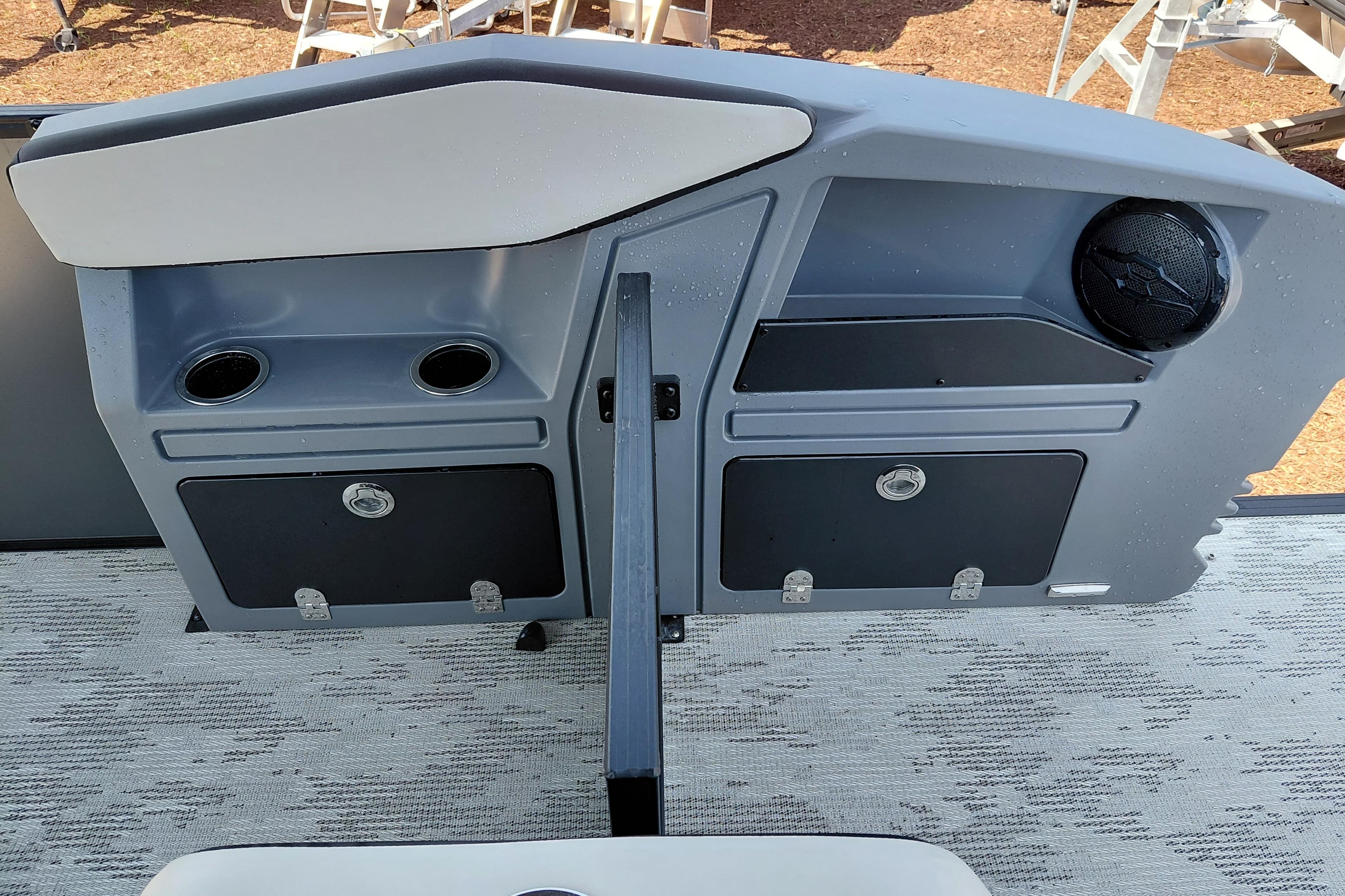 Control panel of 2026 Starcraft VX 24 Q DH boat with cup holders and speaker.
