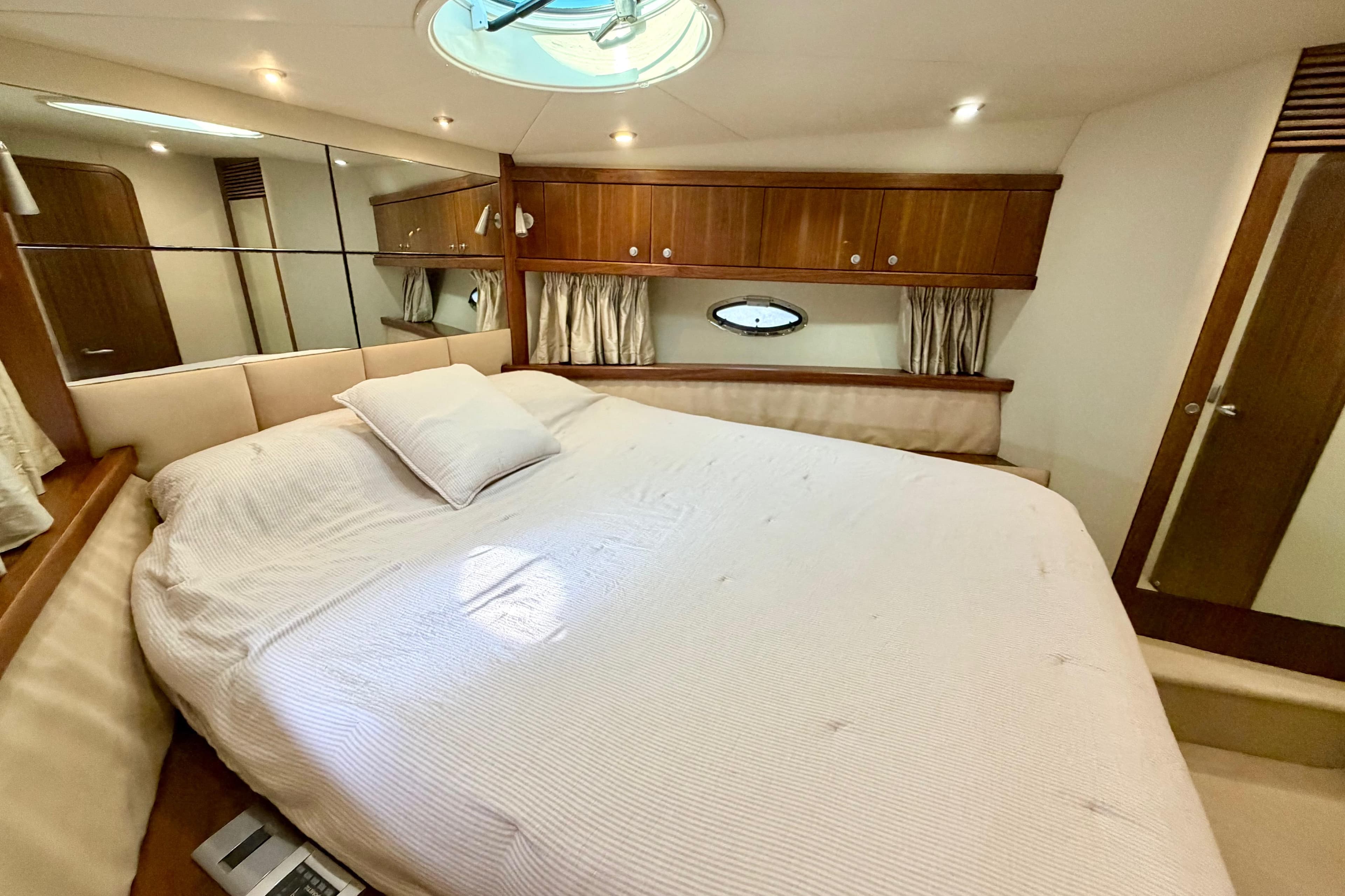 Luxurious cabin interior of 2006 Sunseeker Portofino 47 yacht with elegant wood finishes.