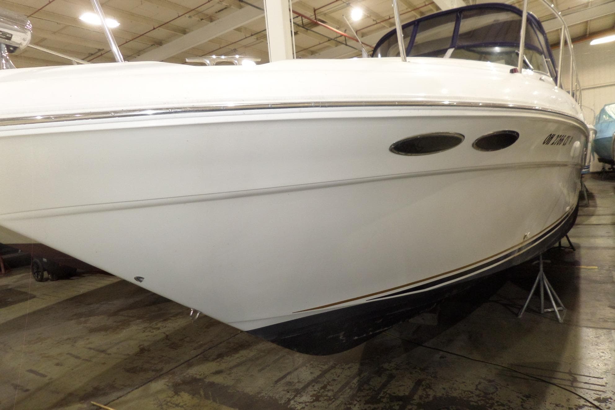2000 Sea Ray 340 Sundancer boat in indoor storage, side view.