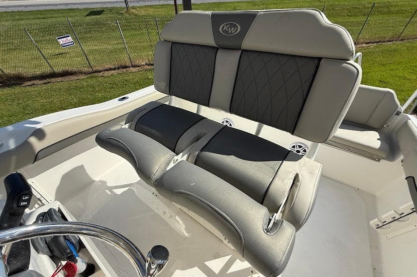 2026 Key West 219 FS boat seating with gray upholstery and steering wheel.