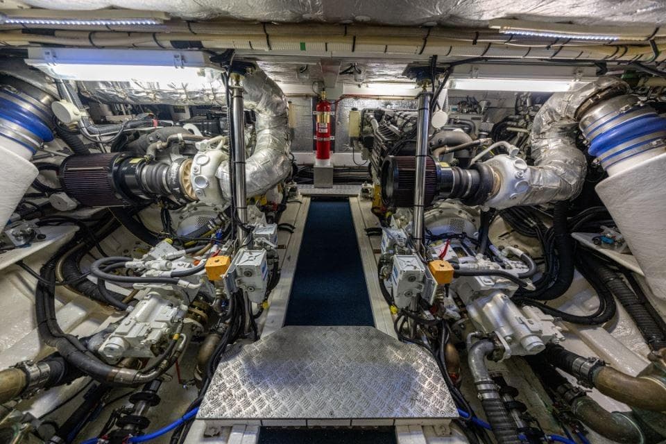 Engine room of a 2007 Aquastar 57 yacht, showcasing complex machinery and equipment.