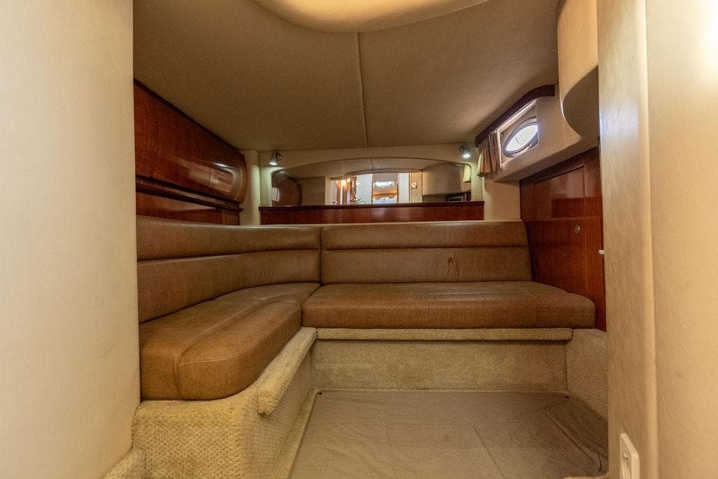 Interior cabin of 2005 Sea Ray 420 Sundancer with beige seating and wood accents.