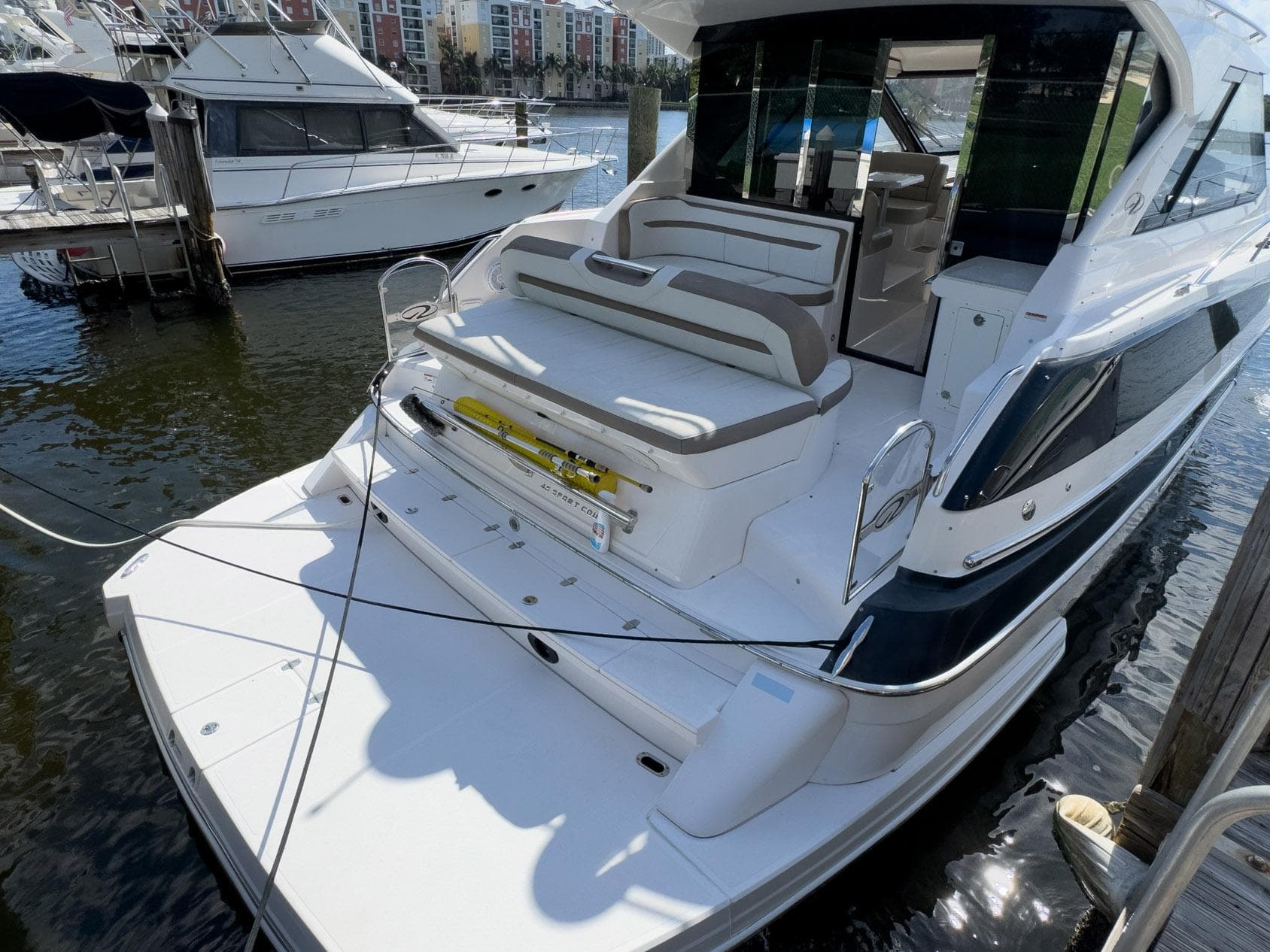 2016 Regal 46 Sport Coupe yacht docked at marina, rear view.