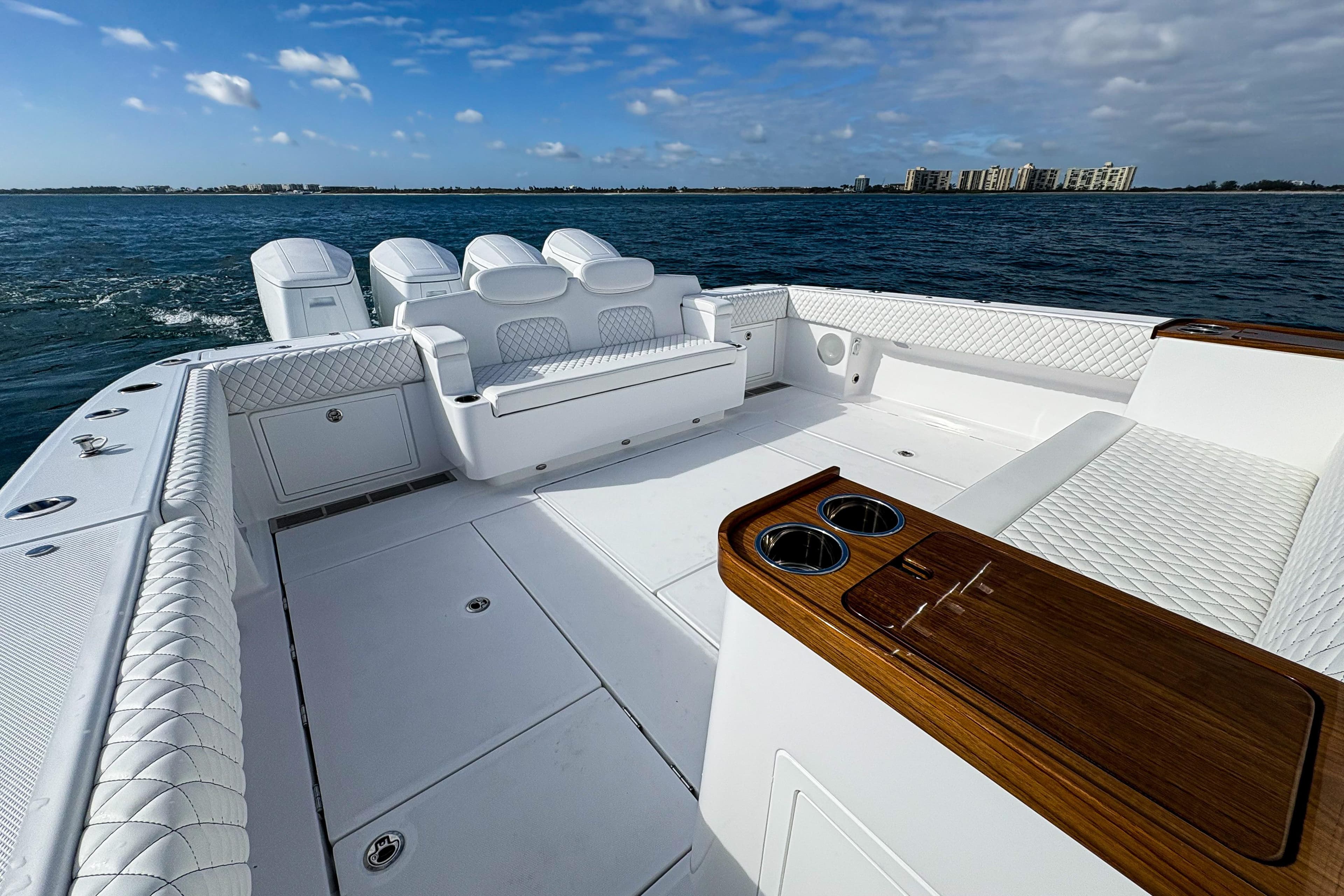 Luxurious 2027 HCB 48 Campeon boat interior with plush seating and ocean view.