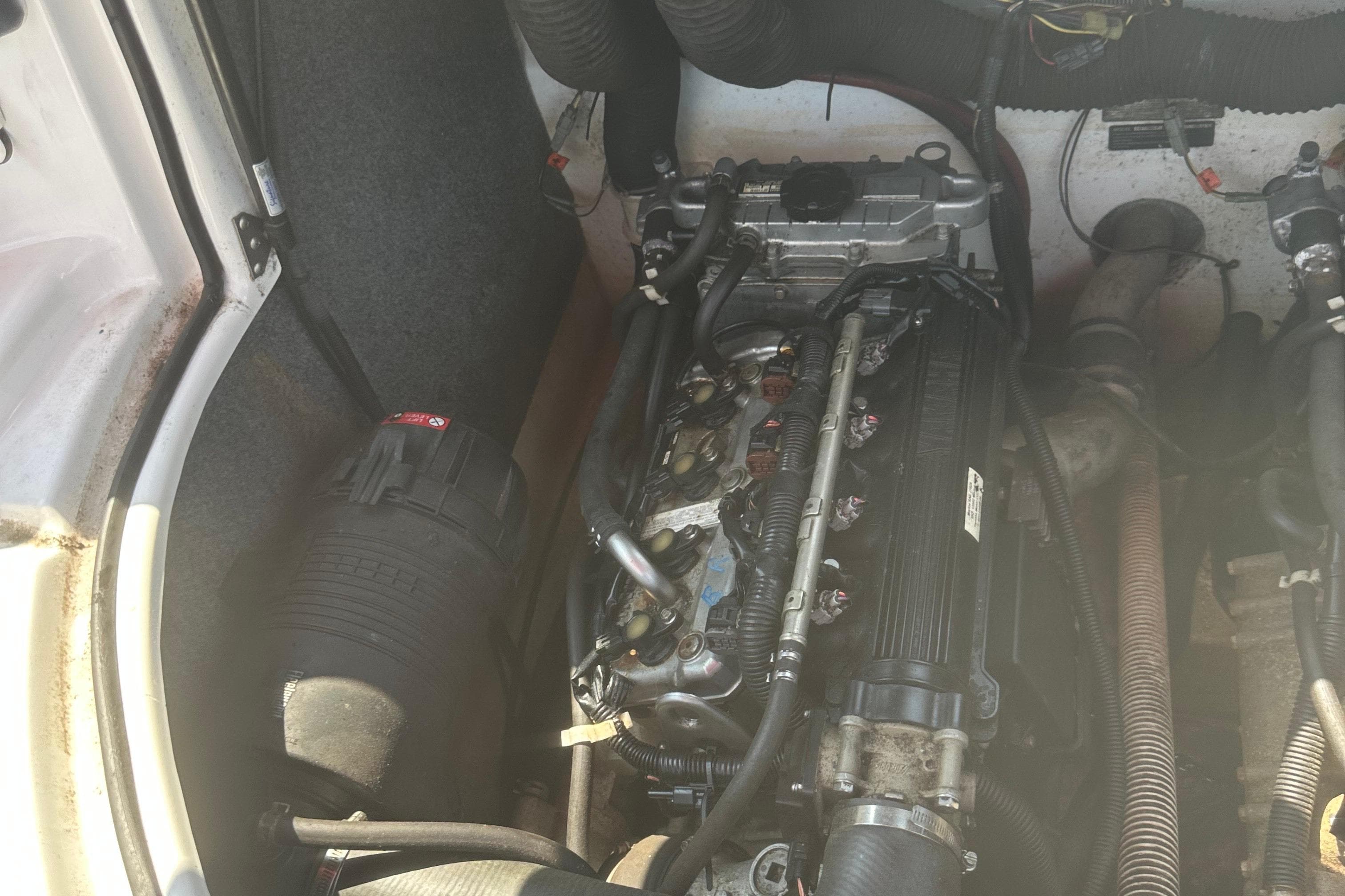 Engine compartment of a 2007 Yamaha Boats SX210, showcasing mechanical components and wiring.