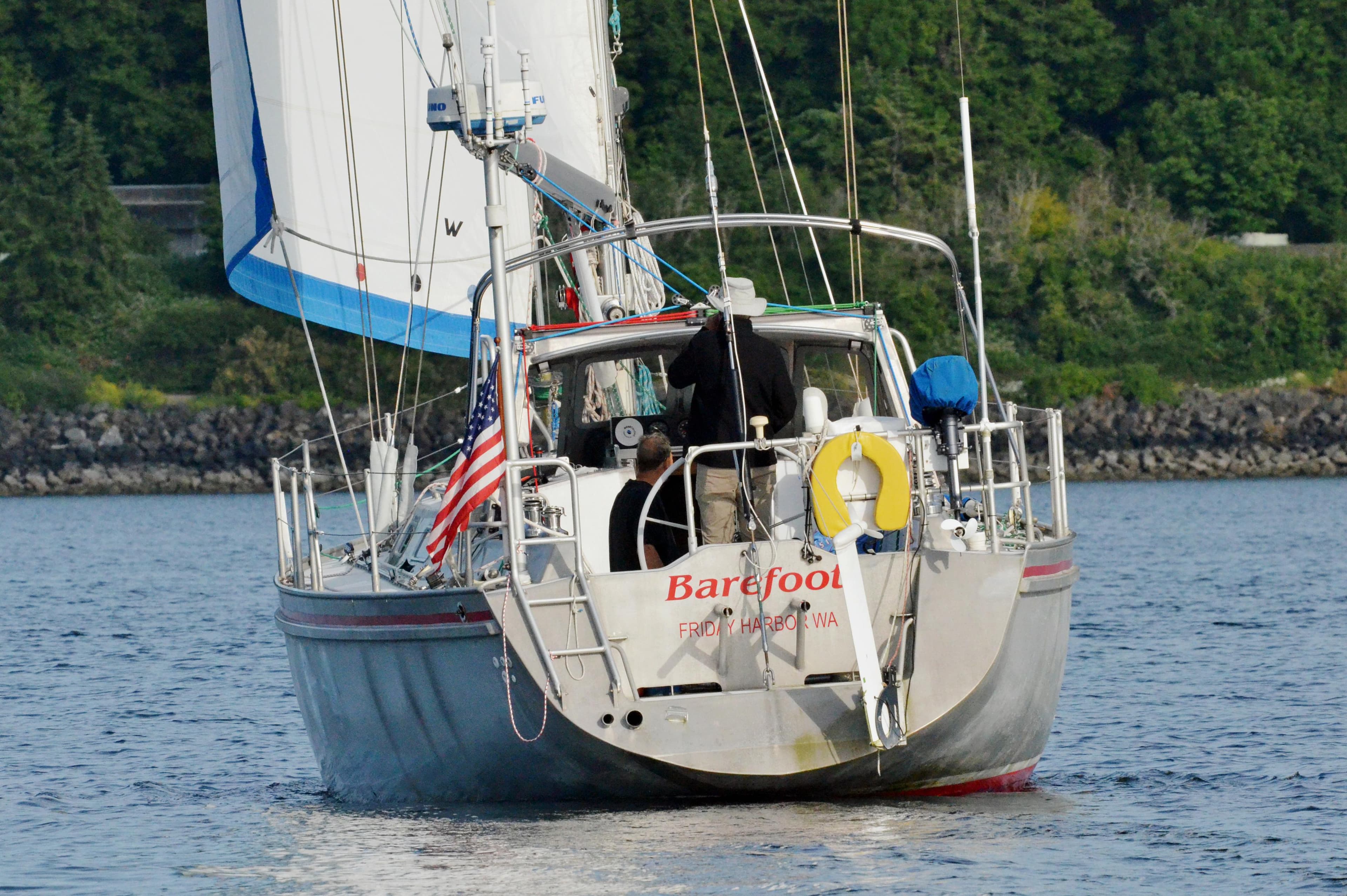 Sailboat "Barefoot" Lavranos 43, 2010 model, sailing on calm waters with lush green background.