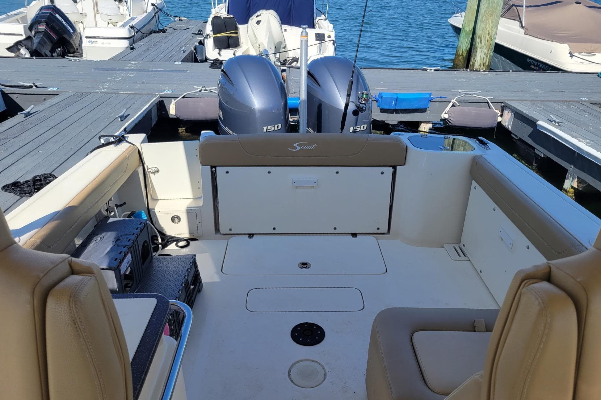 2020 Scout 255 Dorado boat interior with twin 150 engines at dock.