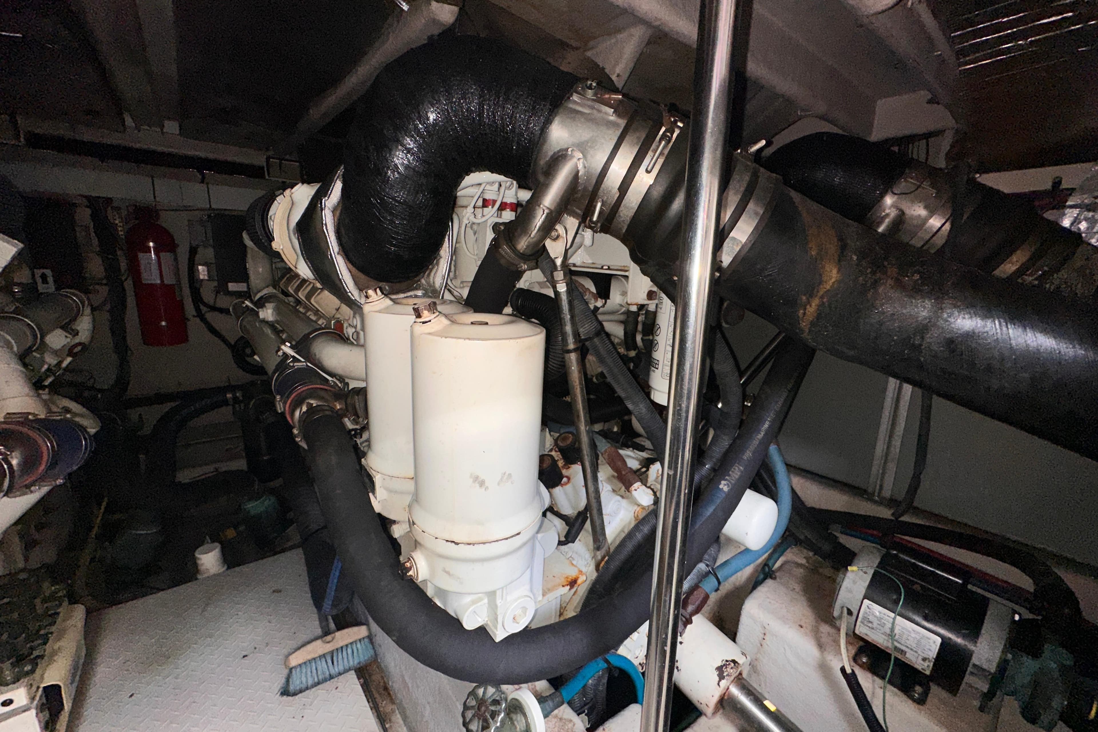 Engine room of a 2006 Sea Ray 58 Sedan Bridge yacht, showcasing complex machinery.