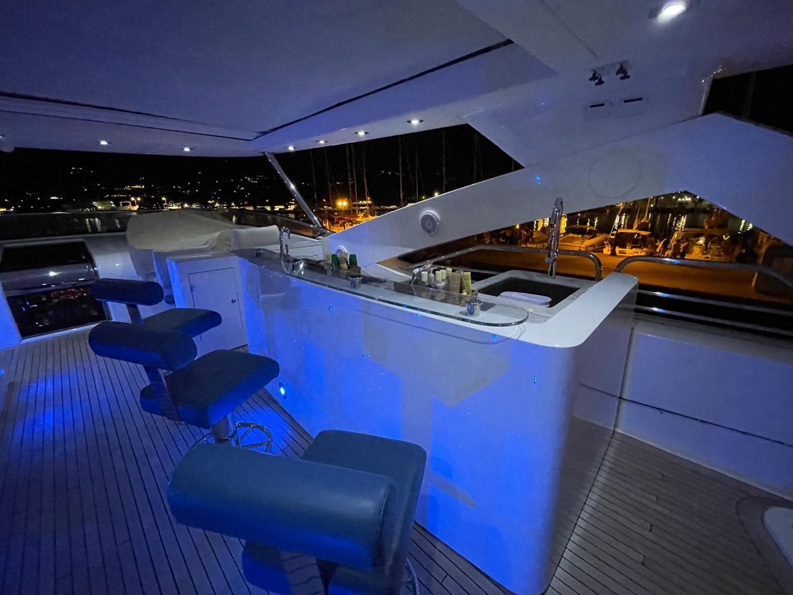Luxurious Sunseeker 30 Metre Yacht 2012 with illuminated bar and seating at night.