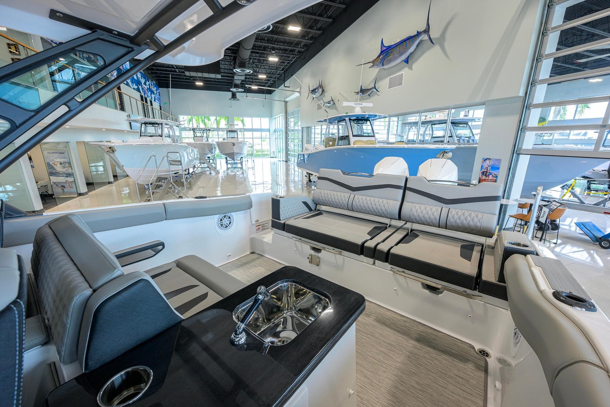 Luxurious interior of 2026 Monterey Elite 30 OB boat in a showroom setting.