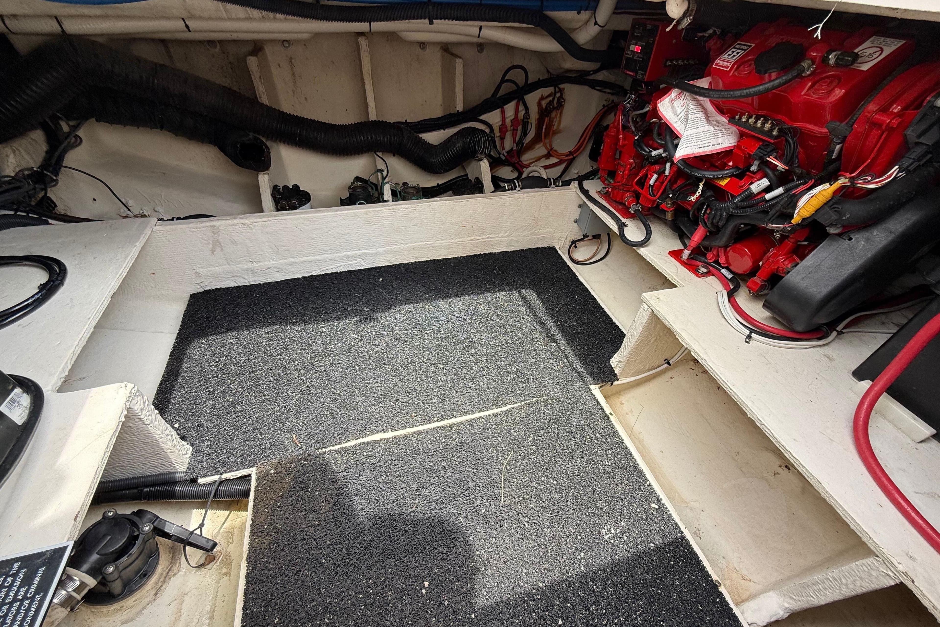 Engine compartment of a 2021 Regal 33 SAV boat, featuring red engine components.