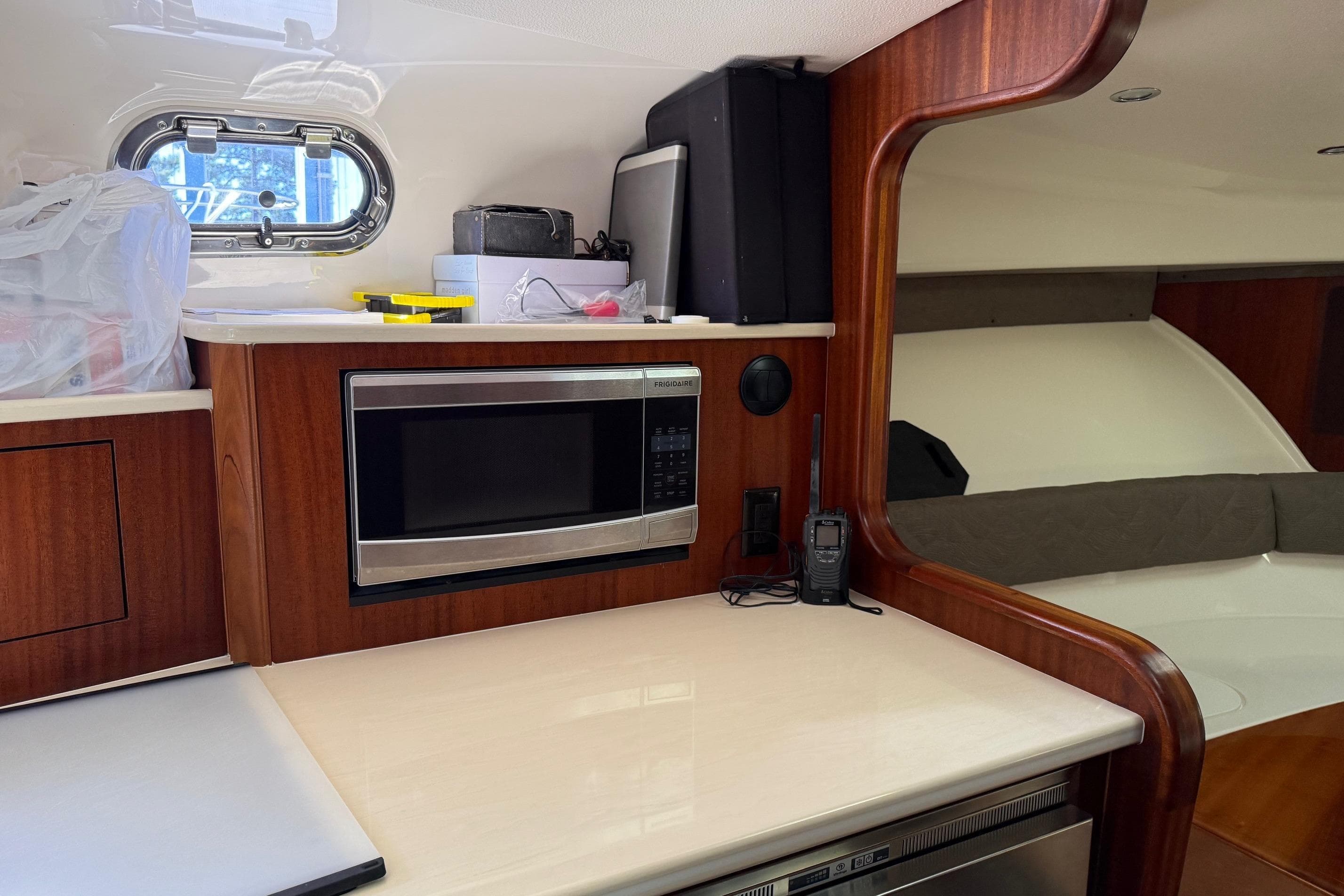 2015 Pursuit OS 385 Offshore interior with microwave, countertop, and window.