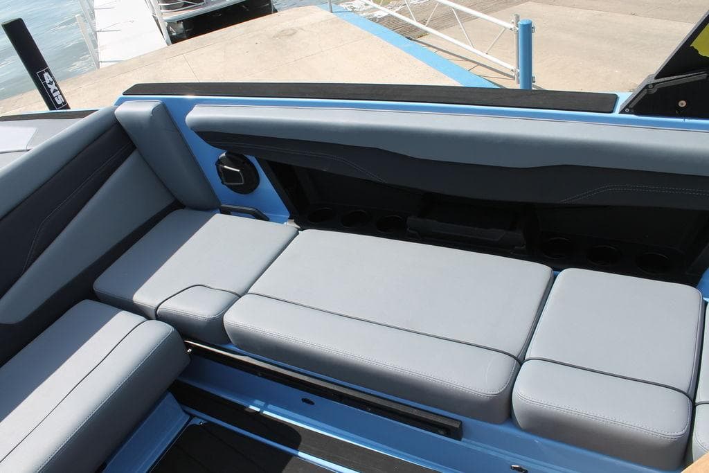 2024 Axis T235 boat interior with gray seating and blue accents.