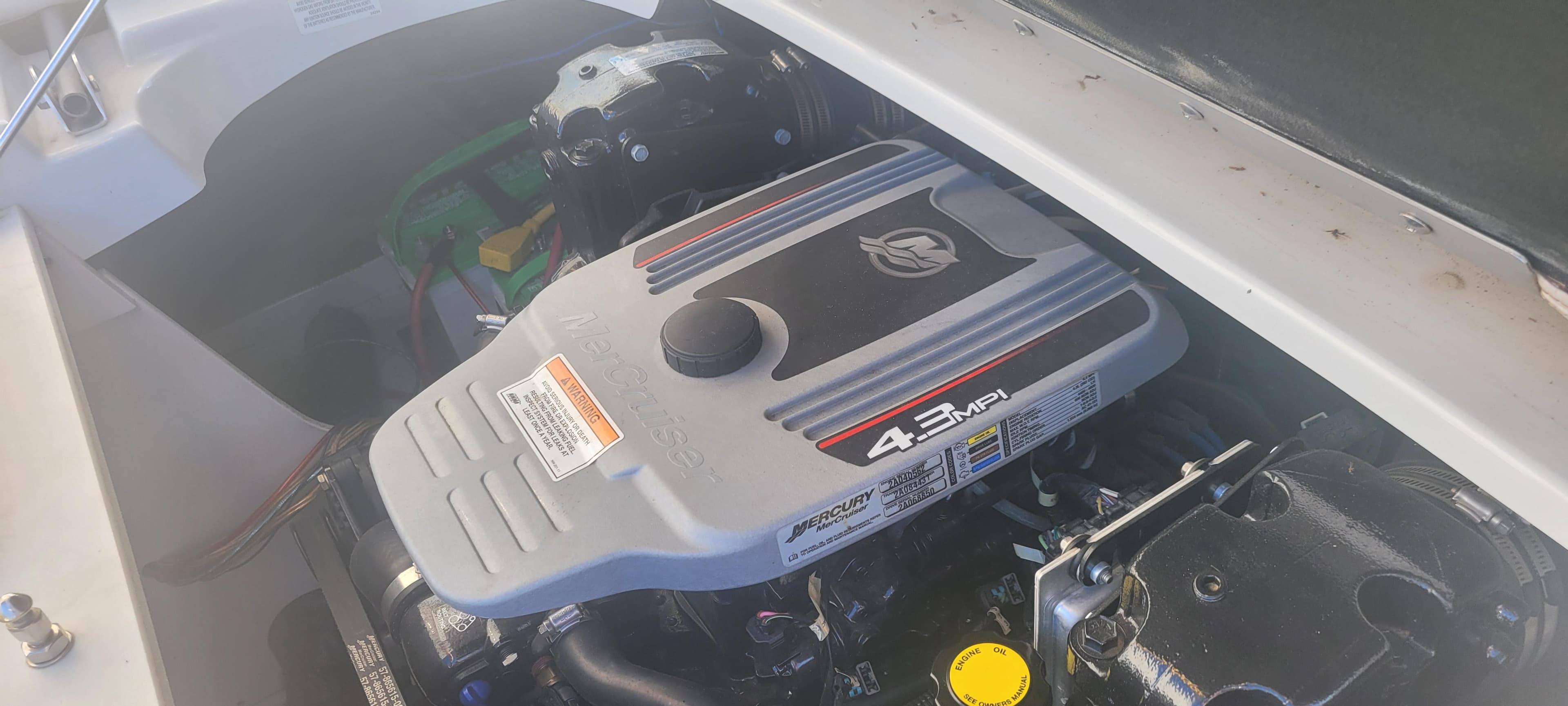 Engine compartment of a 2013 Crownline 21 SS boat, featuring a 4.3 MPI motor.