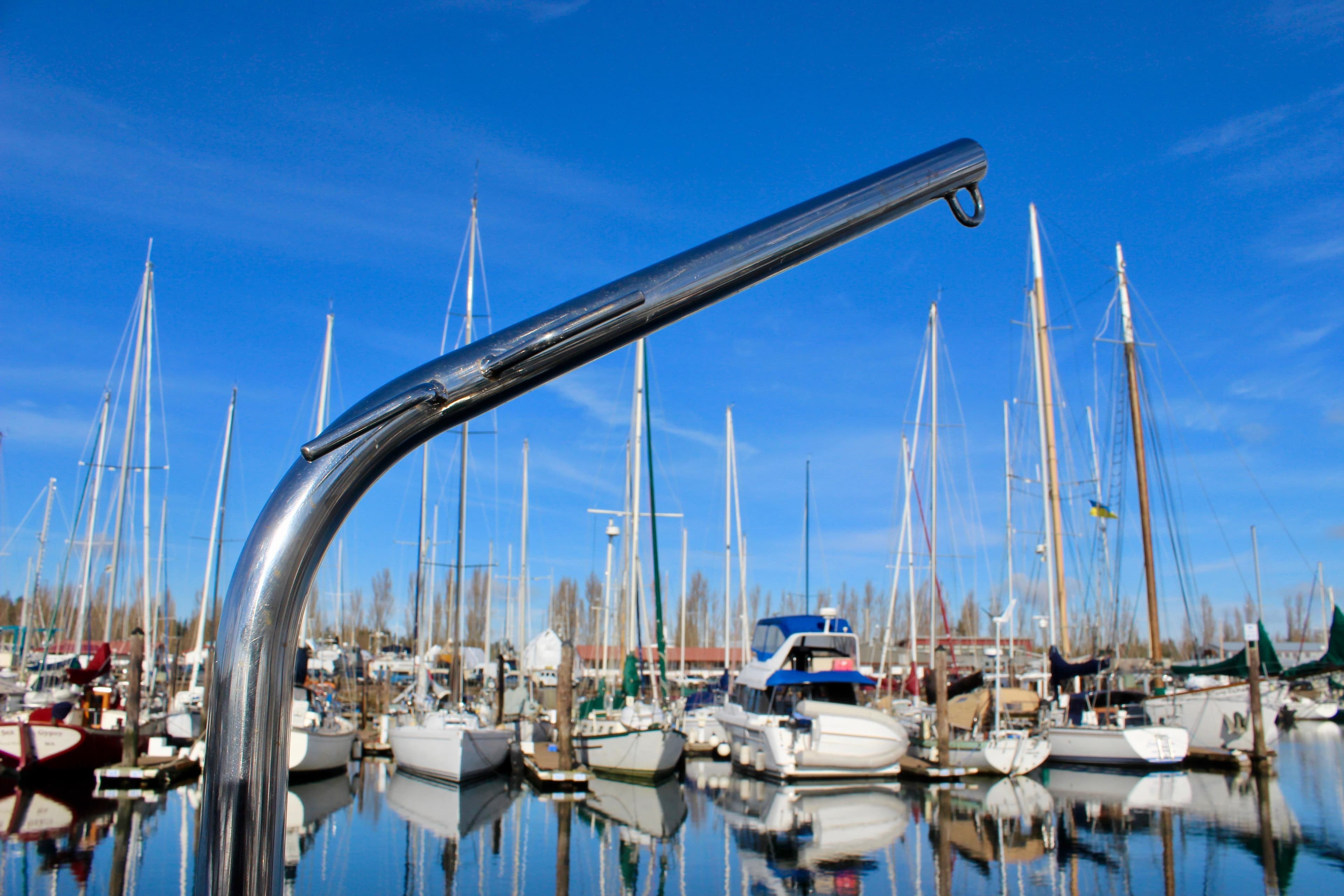 Chrome boat railing with marina background, featuring Valiant 39 sailboats, 1997 model.