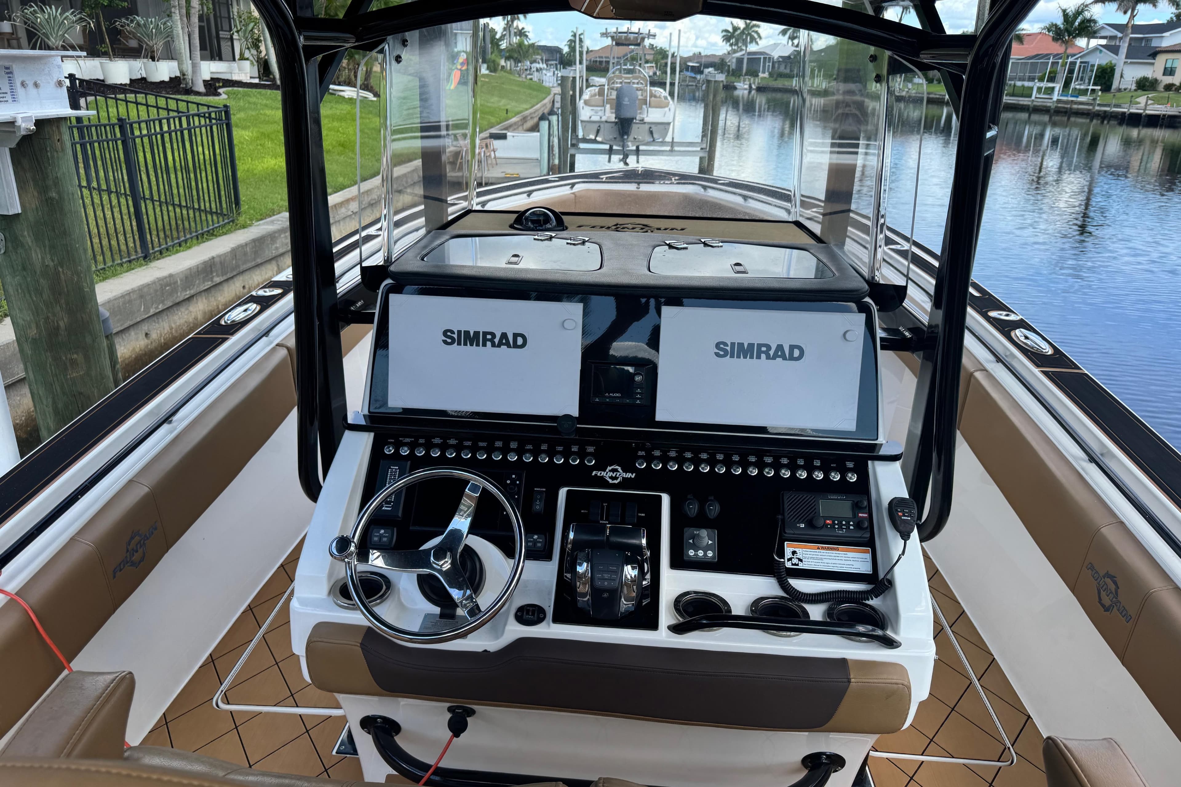 2020 Fountain 38 Center Console boat interior with dual Simrad displays and steering wheel.