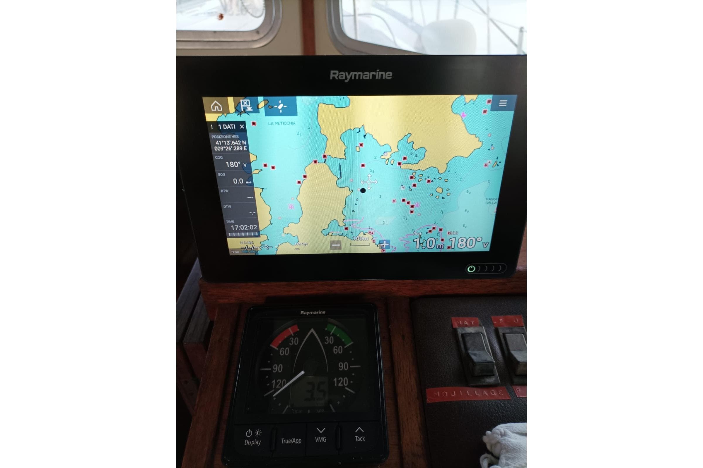 Raymarine navigation display on 1979 Fisher 37 boat, showing nautical map and controls.