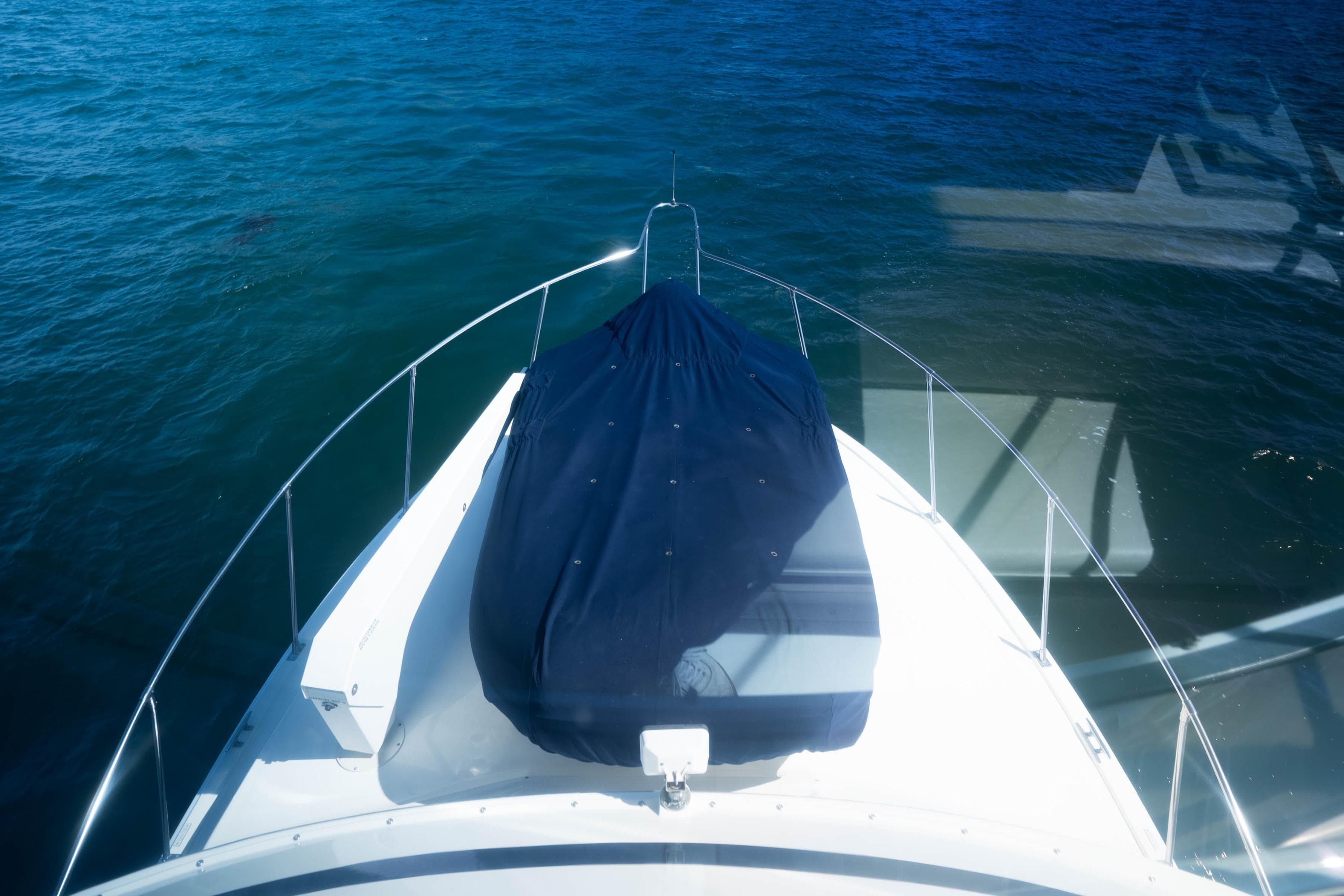 1984 Bertram 35 Convertible boat bow view on calm blue water.