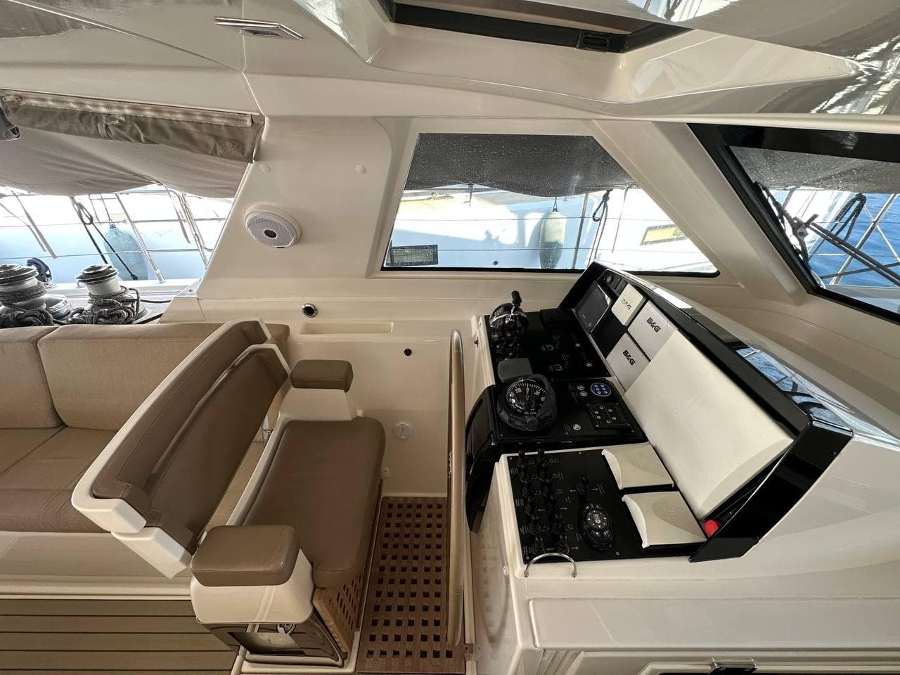 Amel 64 yacht cockpit, 2015 model, featuring modern navigation equipment and comfortable seating.