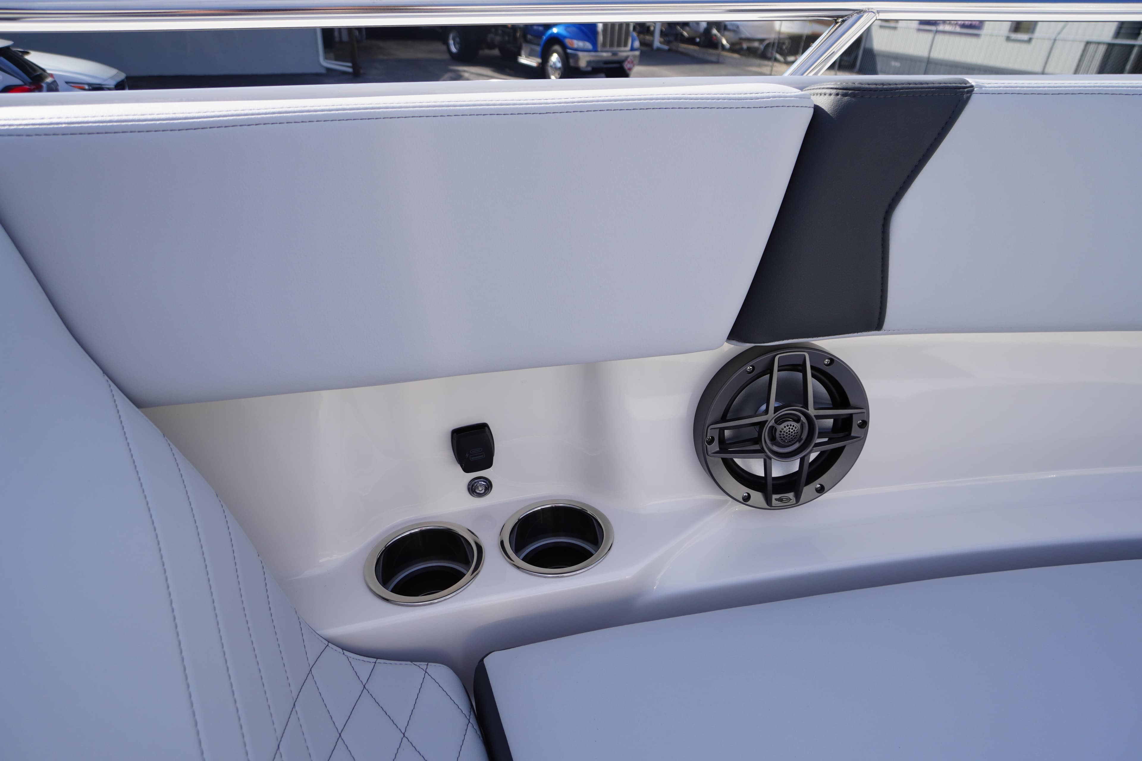Interior of 2026 Chaparral 250 OSX boat with speaker and cup holders.