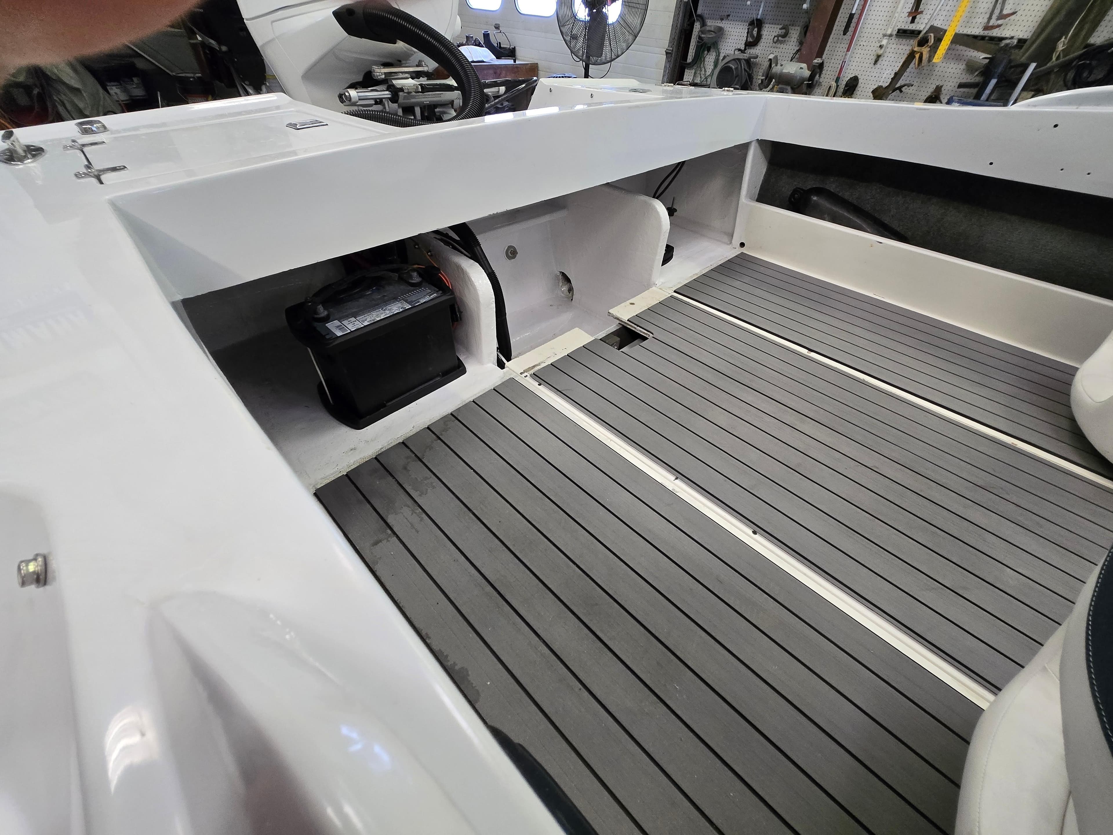 Interior of a 1991 Activator 22 boat showing battery compartment and seating area.